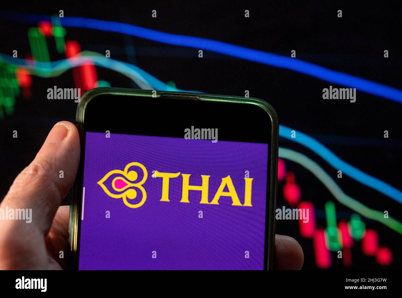China. 4th Dec, 2021. In this photo illustration, a Thai Airways International logo seen displayed on a smartphone with an economic stock exchange index graph in the background. (Credit Image: © Budrul Chukrut/SOPA Images via ZUMA Press Wire) Stock Photo