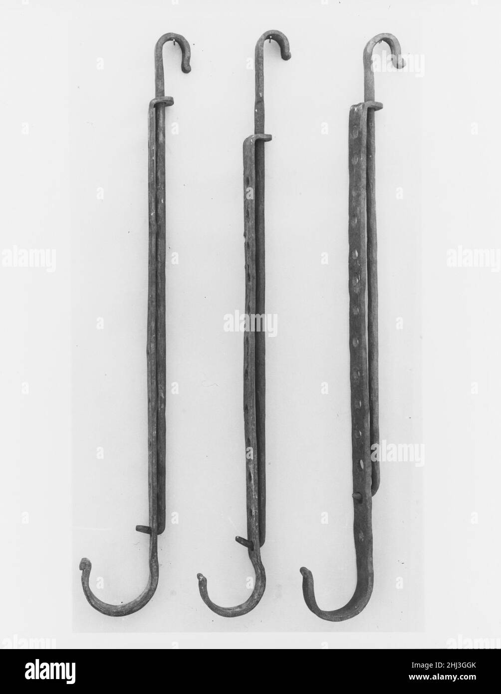 Trammel 18th century The trammel allowed a cook to adjust the cooking temperature by either raising or lowering vessels hanging above the fire. The tool consists of two permanently joined hooks that slide vertically and lock into place at frequent intervals. The device would be suspended from a lug pole placed high inside the fireplace.. Trammel  8769 Stock Photo