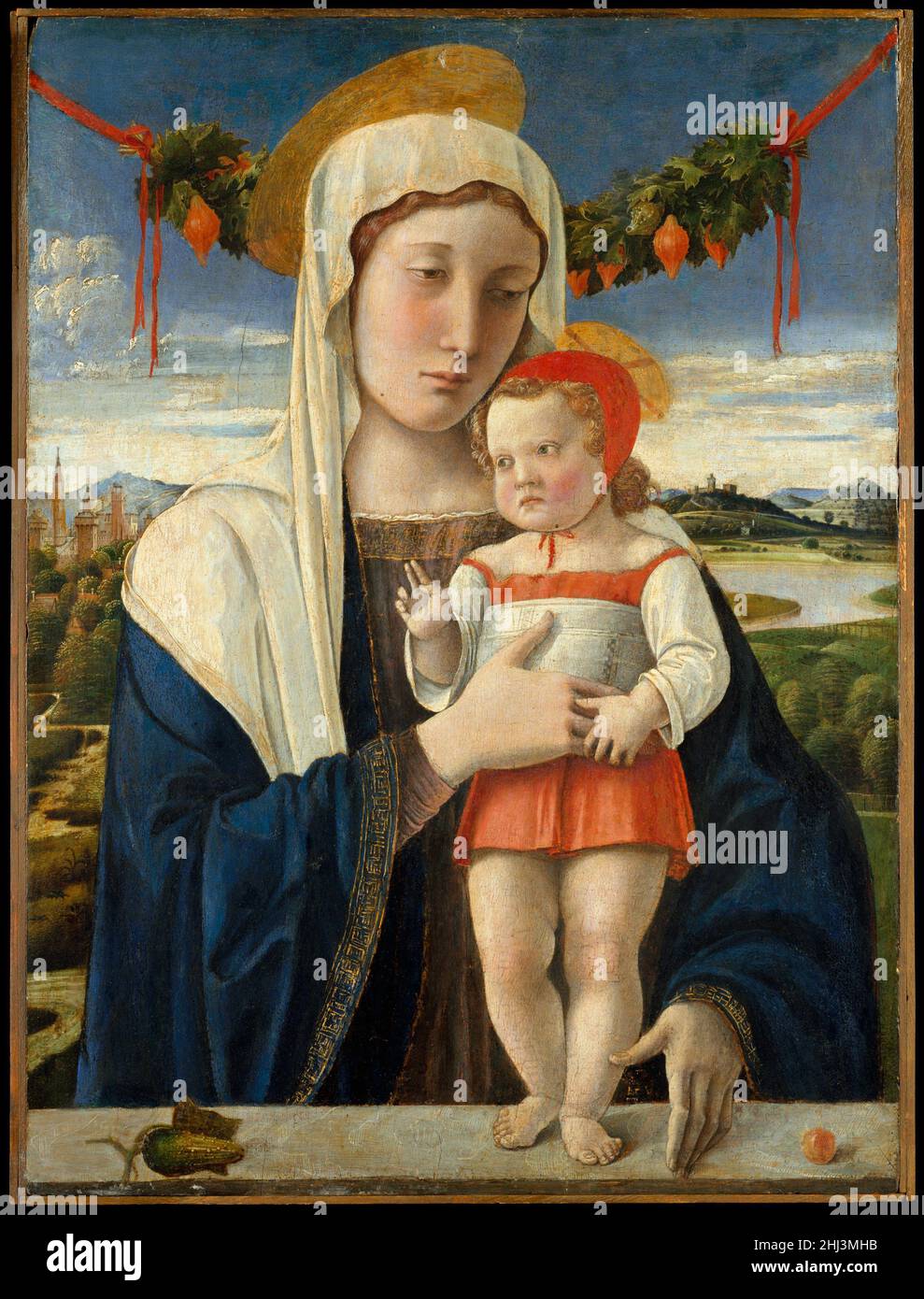 Madonna and Child ca. 1470 Giovanni Bellini Italian This early work by the Venetian painter, Giovanni Bellini, reveals the profound influence of his brother-in-law, the Paduan master Andrea Mantegna, both in the figure types and the inclusion of the garland. The treatment of the landscape and the use of the oil medium, with which Giovanni may have been experimenting since the 1460s, were likely inspired by Netherlandish painting. Bellini creates a dramatic connection between the worshipper and subject through the Virgin’s left hand, extending across the parapet, and her fingertip, which reache Stock Photo