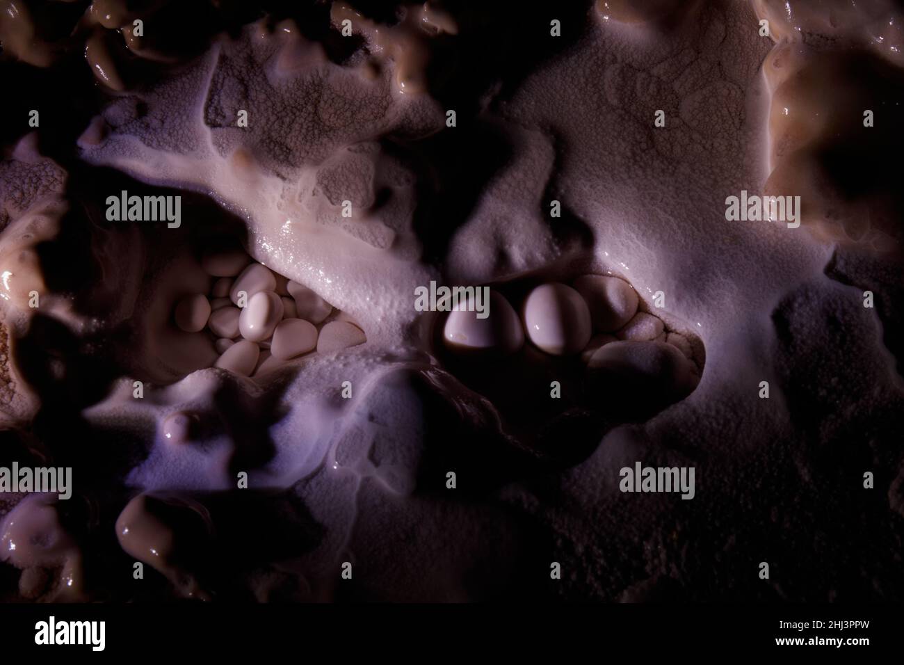 Top view of the white pearls in the dark cave - texture background ...