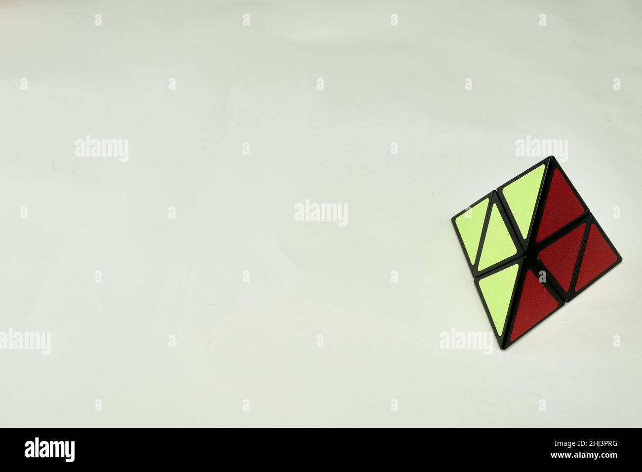 rubik's cube pyramorphix, solved on white background with copy space 2 Stock Photo