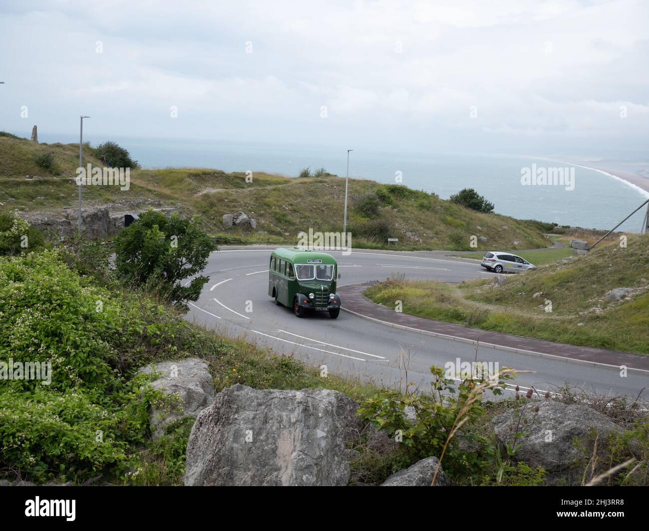 Bus climbing the hill at Portland Heights on a rally to Portland Bill Stock Photo