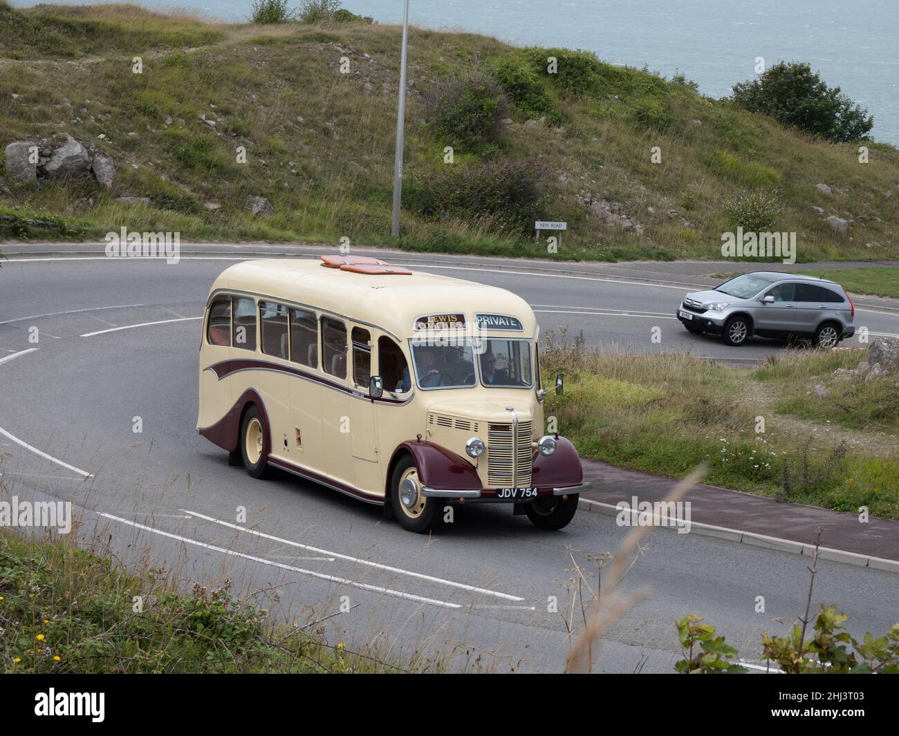 Bus climbing the hill at Portland Heights on a rally to Portland Bill Stock Photo