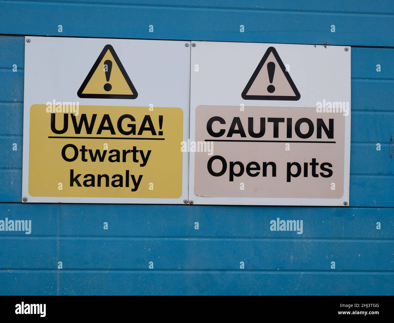Warning sign Polish and English Open Pits Stock Photo
