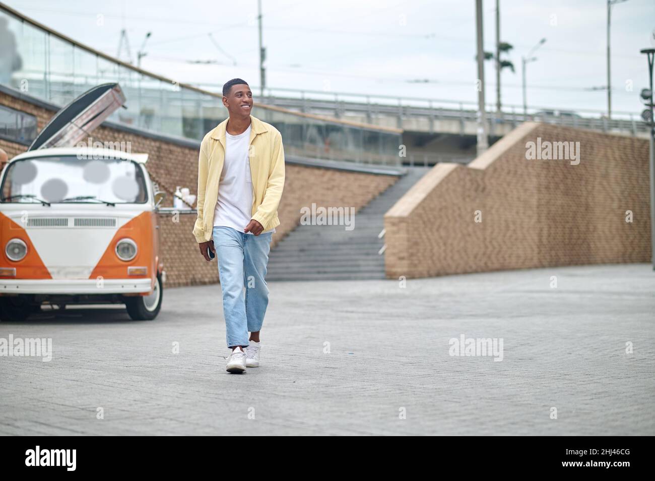 Man walking down street looking to side Stock Photo