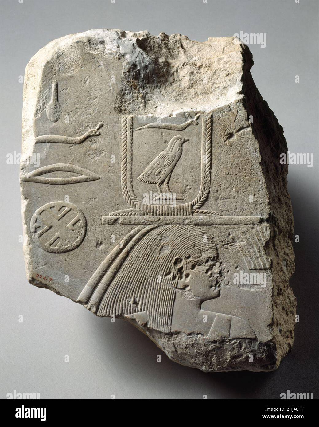 Relief with the head of a female personification of an estate ca. 2551–2528 B.C. Old Kingdom This upper part of a female figure is the personification of one of Khufu's agricultural estates. The placement of the pharaoh's name on a crossbar with feathery protrusions in front and streamers at the back indicates that the figure has been assimilated to a standard, an emblem on a pole used to designate administrative entities. With the hieroglyphs behind the head, the name of the estate can be read 'Perfect is Khufu.' Estates were either extant or newly established settlements dedicated to providi Stock Photo