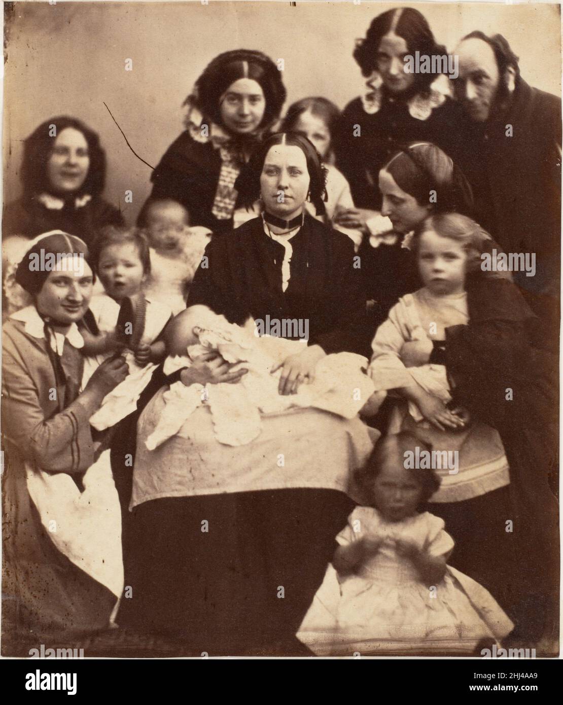 Mr. and Mrs. R. B. Tennent, Mrs. E. H. Yates, Mrs. Brandram, their Children and Three Nurses 1850s Unknown In 1853 Edmund Hodgson Yates (1831-1894), a pugnacious society journalist and satirical playwright, married Louisa Wilkinson, and the couple had four sons in as many years. Edmund was a son of traveling actors, Louisa the daughter of a Pall Mall swordmaker, but the leading lights of literary, journalistic, dramatic, and bohemian London all rubbed elbows in the Yateses' lively and informal household. Their friends included the young Reverend Charles Lutwidge Dodgson, whose humorous writing Stock Photo