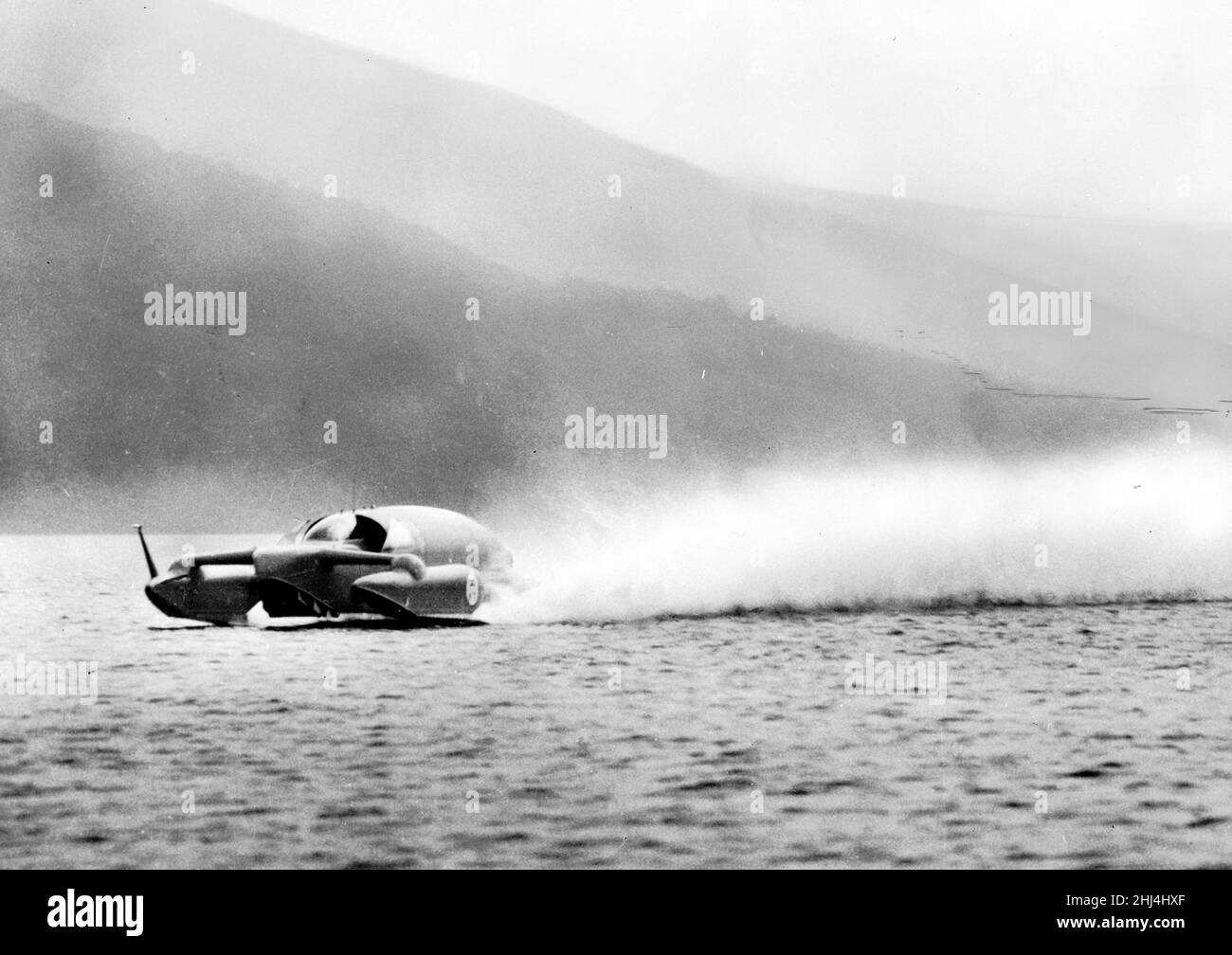 Donald Campbell breaks the World Water Speed Record at Coniston Water, 19th September 1956.  He set a record of 225.63 mph, nine miles faster than his previous world record set on Lake Mead, Nevada, last November. Stock Photo