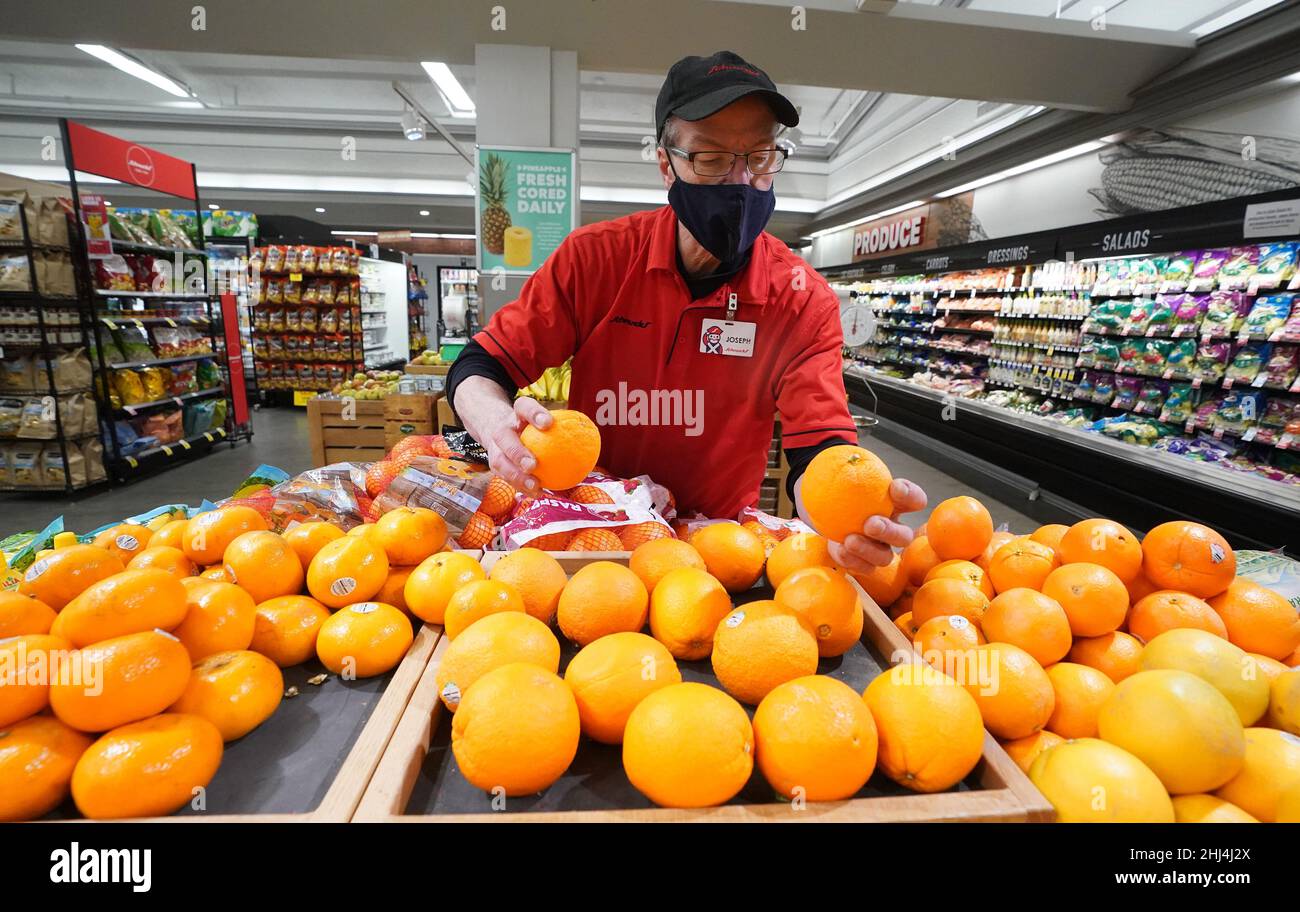 Ladue, United States. 26th Jan, 2022. Employee Joseph Hayes checks the color of a batch of oranges he has placed for sale at Schnucks Markets in Ladue, Missouri on Wednesday, January 26, 2022. The U.S. Department of Agriculture warned orange growers may see a low crop yield this year because of the Citrus Greening Diseases. Infected trees bear fruit that are smaller, higher in acidity and lower in sugar. Officials say this years crop could be one of the worst seasons since World War II. Photo by Bill Greenblatt/UPI Credit: UPI/Alamy Live News Stock Photo