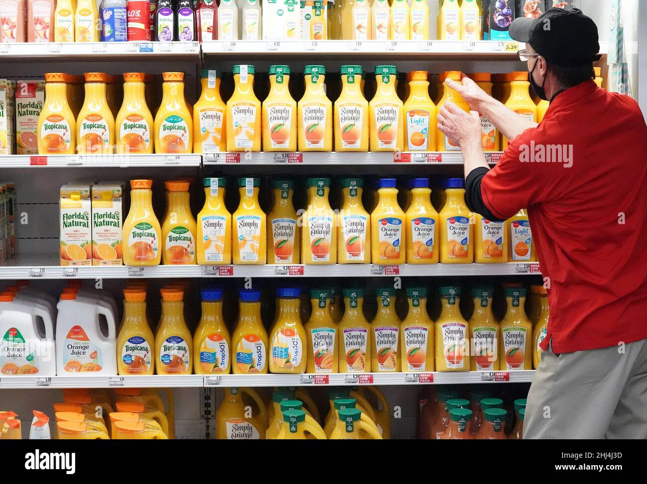 Ladue, United States. 26th Jan, 2022. Employee Joseph places orange juice on a shelve for sale at Schnucks Markets in Ladue, Missouri on Wednesday, January 26, 2022. The U.S. Department of Agriculture warned orange growers may see a low crop yield this year because of the Citrus Greening Diseases. Infected trees bear fruit that are smaller, higher in acidity and lower in sugar. Officials say this years crop could be one of the worst seasons since World War II and juice prices will increase as well. Photo by Bill Greenblatt/UPI Credit: UPI/Alamy Live News Stock Photo