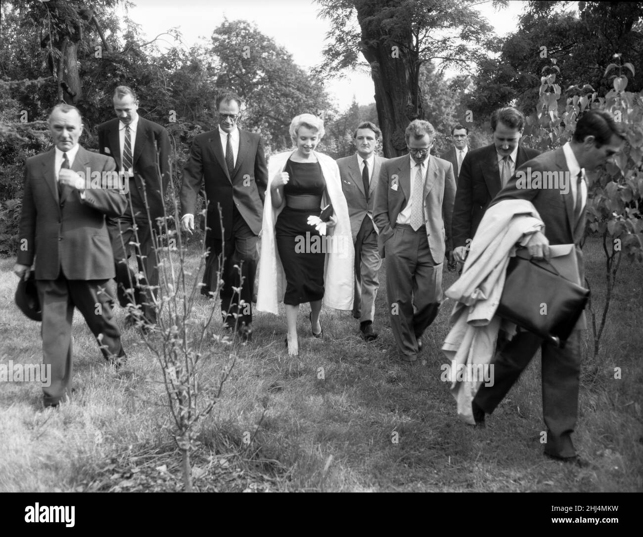 Marilyn Monroe and her husband, playwright Arthur Miller (3rd from the left), pictured in Englefield, Surrey, Picture taken 15th July 1956 The couple had married on 29th June of 1956.  Marilyn Monroe is in England to film 'The Prince and the Showgirl', with Sir Laurence Olivier. She is living in Parkside House on a large country estate in Englefield Green for the entire stay.  Marilyn Monroe was born Norma Jeane Mortenson on June 1, 1926 Los Angeles, California, U.S.A. and died August 5, 1962 (aged 36) Los Angeles, California, U.S.A. Stock Photo