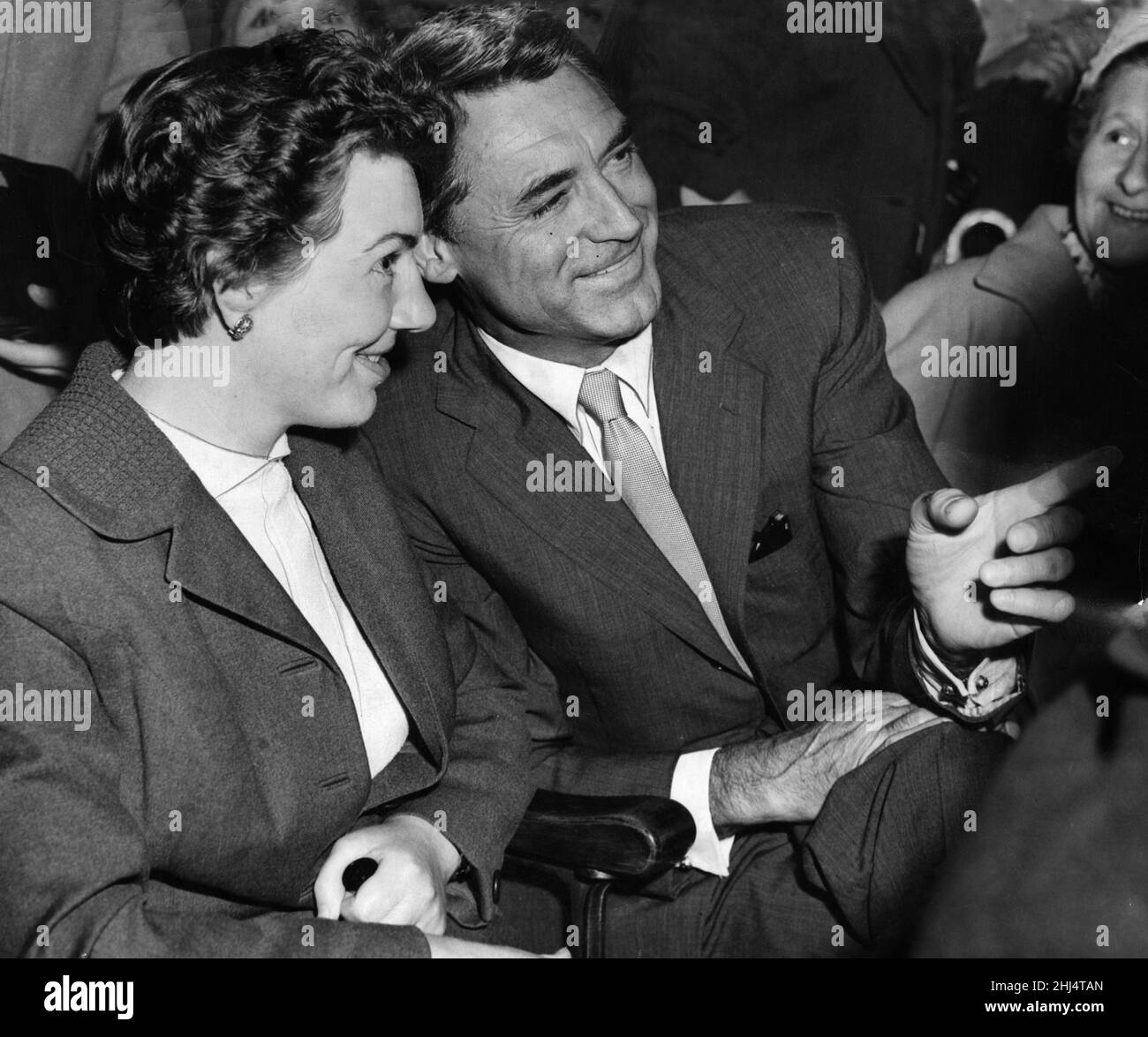 Film star Cary Grant sits in the stalls of the Regal Cinema in Glasgow and chats with Mrs Nan Lynch of Busby about the trade showing of his new film with Ingrid Bergman 'Indiscreet'. 12th July 1958. Stock Photo