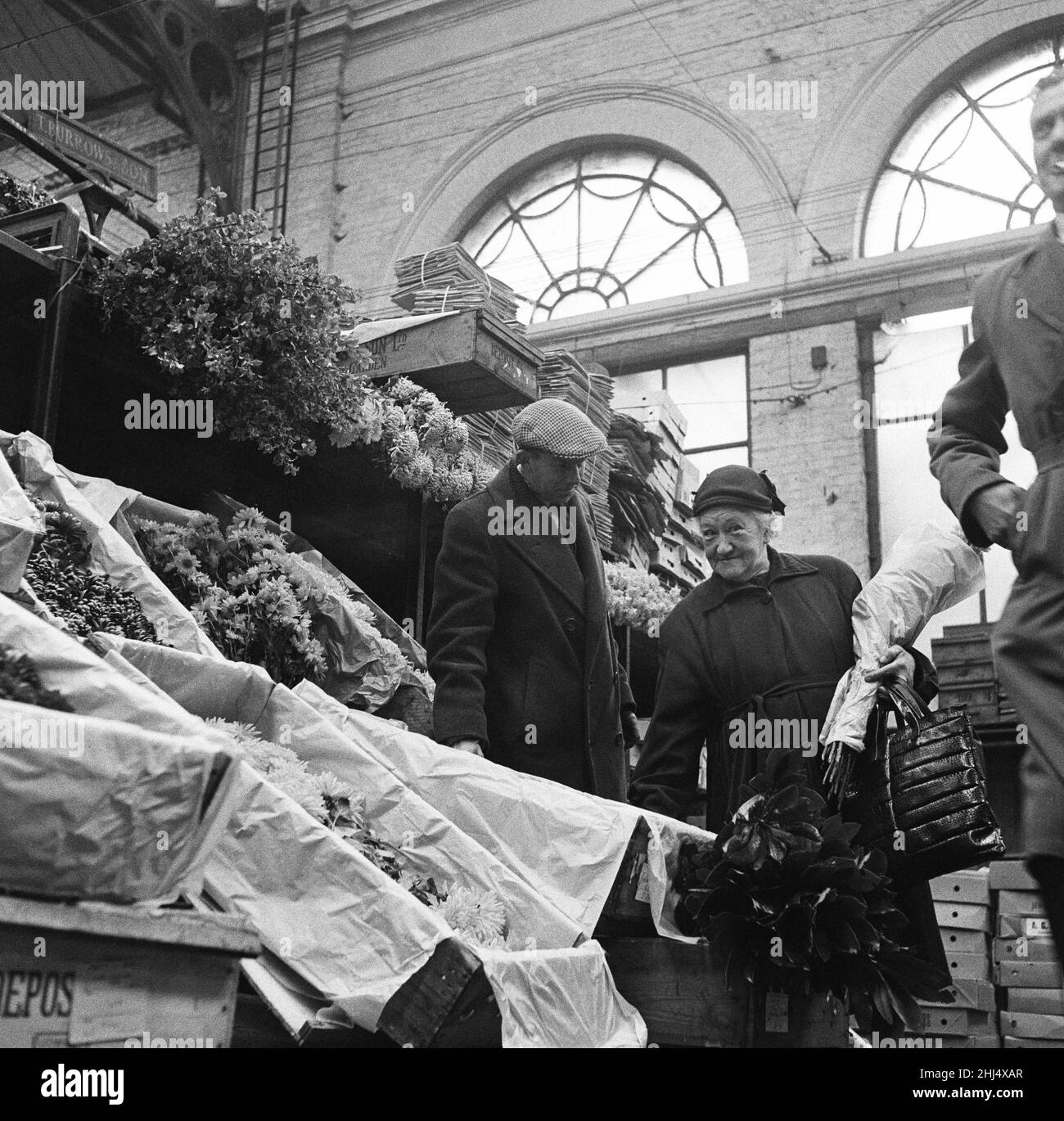 The Ladies of Covent Garden, Covent Garden, London.A lady shops for flowers.  Picture taken 9th November 1960. Stock Photo