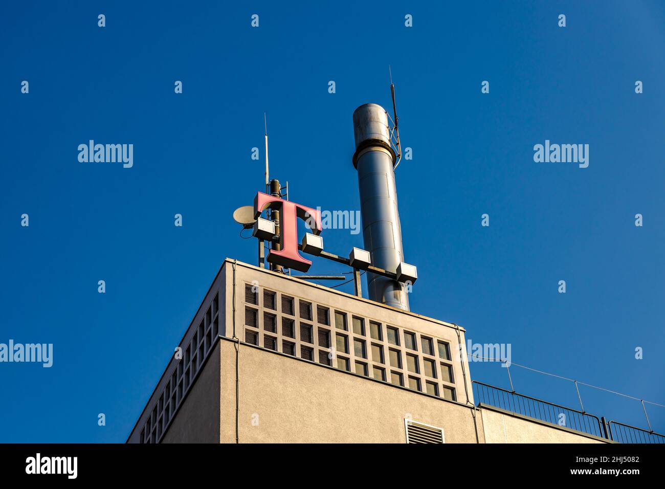 GIESSEN, GERMANY - 2021 04 09: T-Mobile Sign on a Building in Giessen beneath a roof. Stock Photo