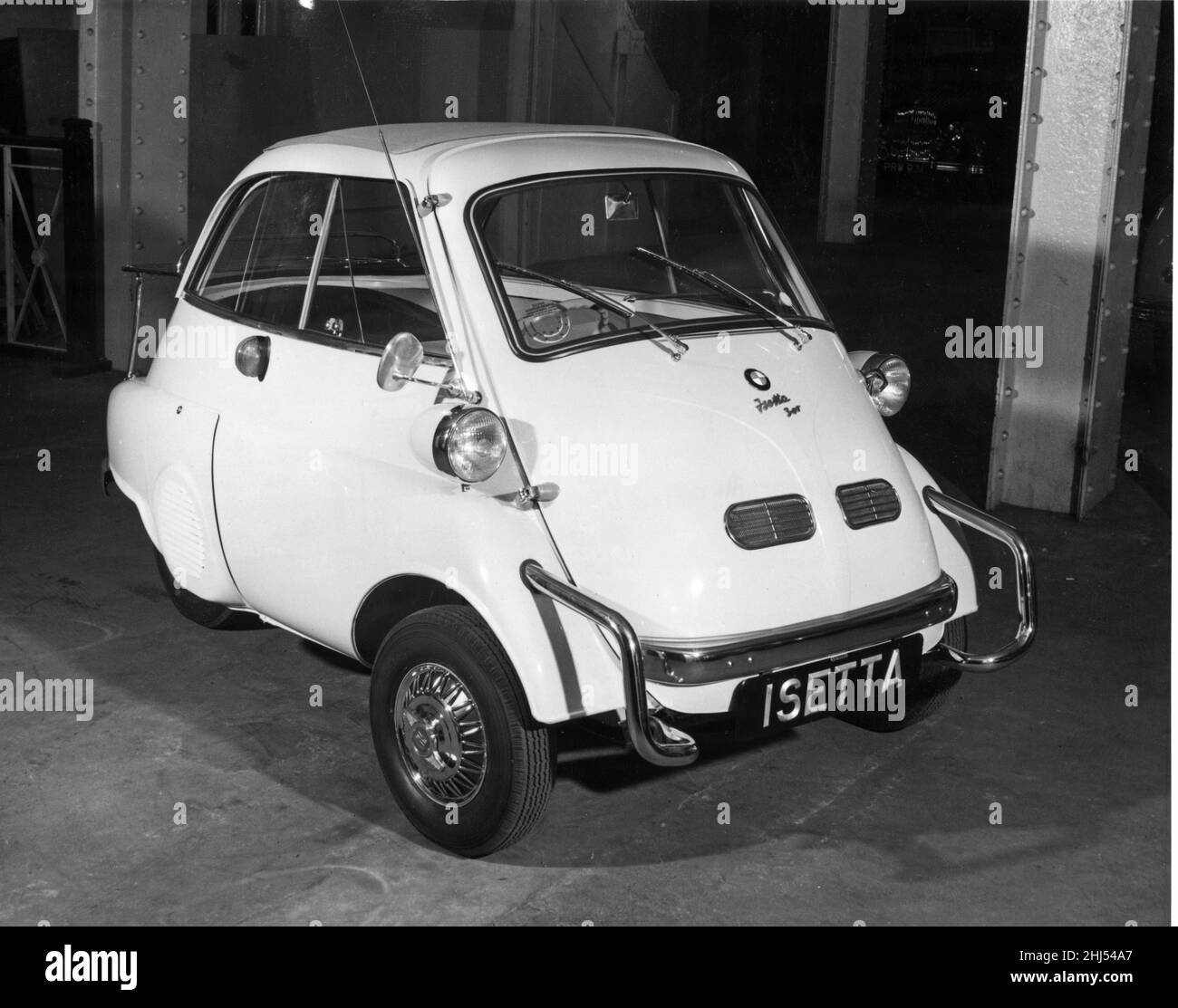 The British Manufactured BMW Isetta, pictured in London at The Dorchester Hotel, The car was previously made in Germany to Italian design, now it will be manufactured at a locomotive works in Brighton, Sussex, Picture taken 2nd April 195 The Isetta is an Italian-designed microcar built under license in a number of different countries.  Because of its egg shape and bubble-like windows, it became known as a bubble car, a name also given to other similar vehicles.  In 1955, the BMW Isetta became the world's first mass-production car to achieve a fuel consumption of 3 L/100 km (94 mpg¿¿imp; 78 mpg Stock Photo