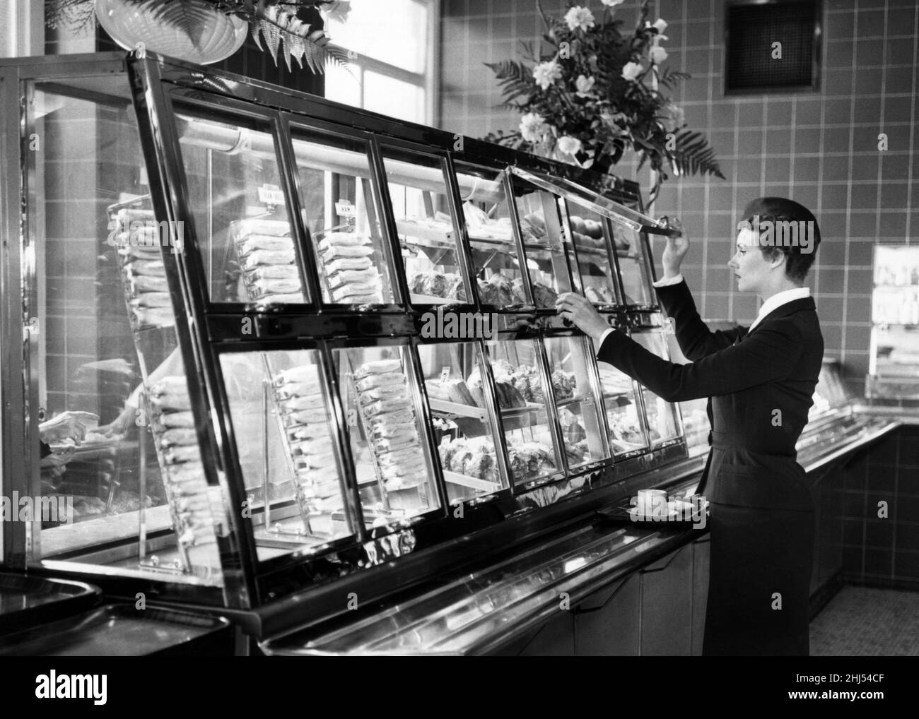 New refrigerated self service snack bar at St Pancreas Station, London, 15th October 1959. Called The Midland, it is the first of many new style cafeterias to be installed by British Railways at railway stations. Pictured, Tonie Funnell, 25 year old British Railways hostess. Stock Photo