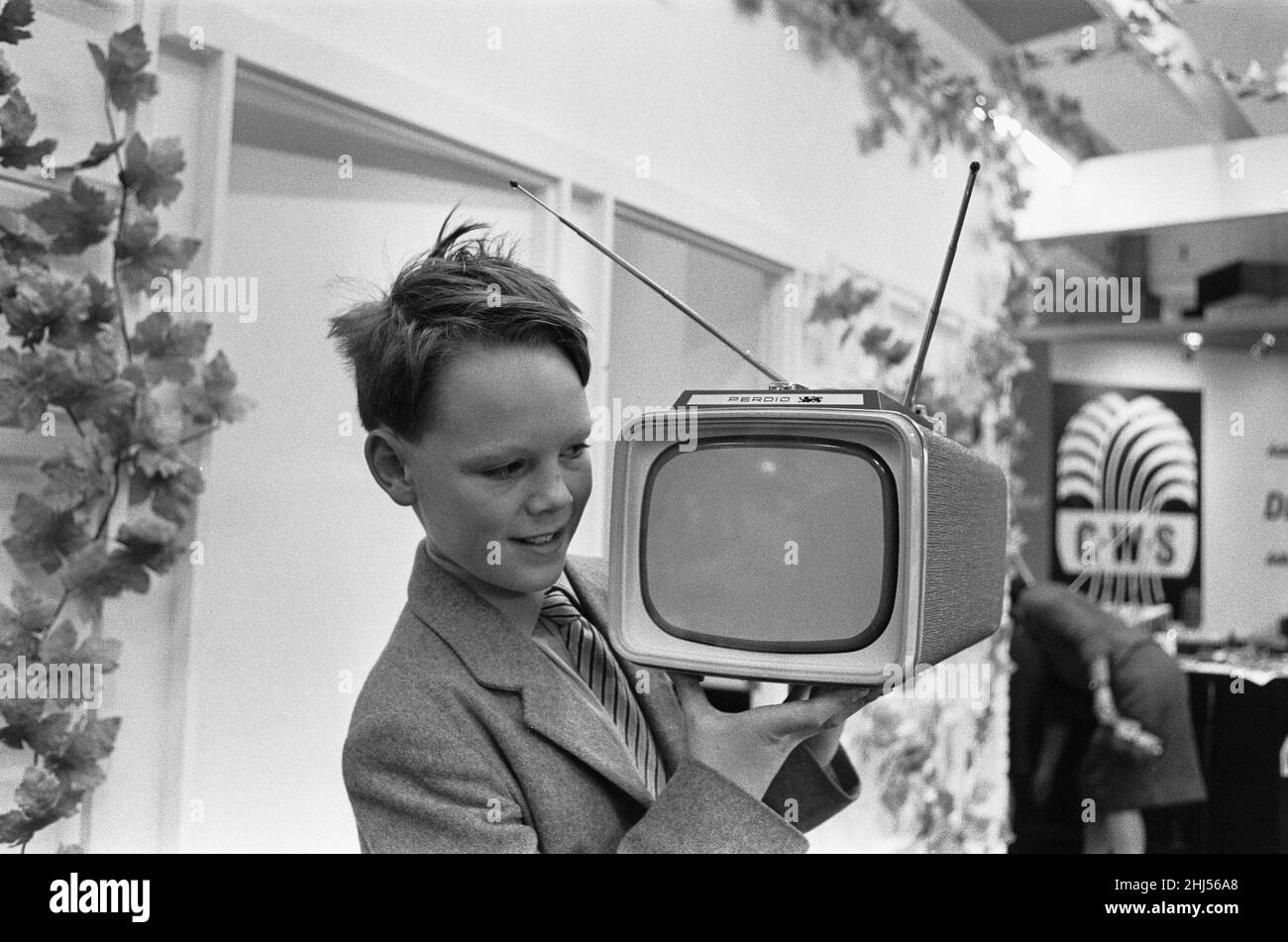 A young boy demonstrating the new Perdio Portorama portable television receiver at the National Radio Show, at Earls Court, London 22nd August 1961 Stock Photo