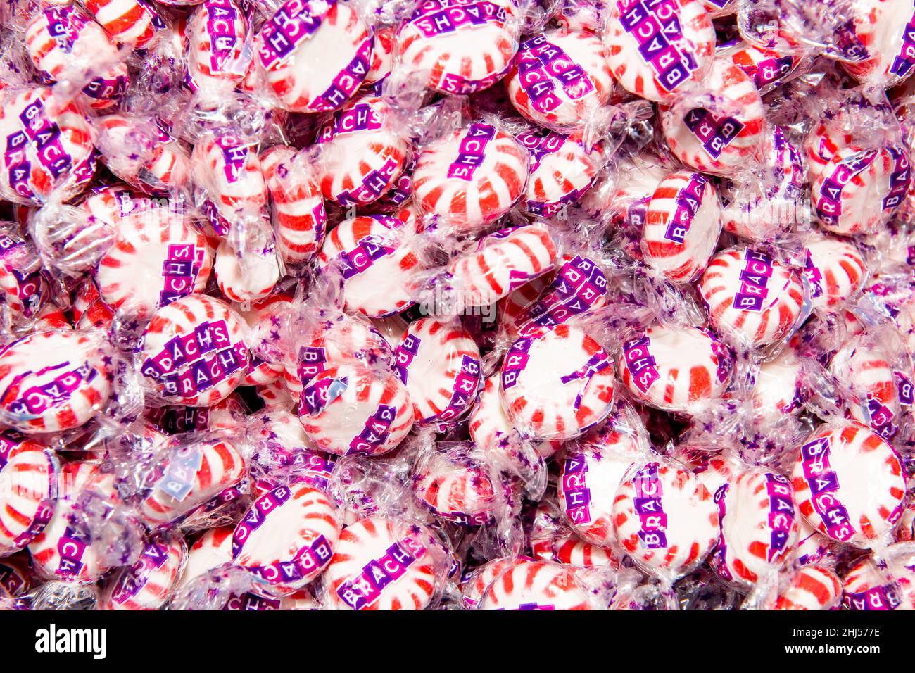 A display of individually wrapped red and white Brach's Star Brites  Peppermint Starlight Mints Hard Candy Stock Photo - Alamy