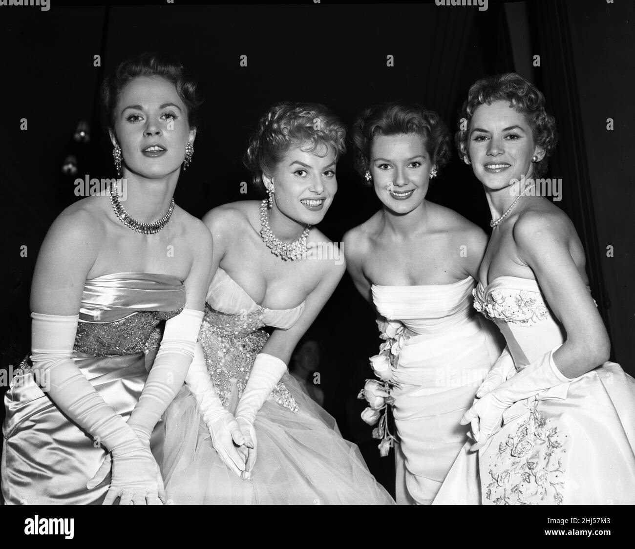 British Actresses preview the evening dresses they will be wearing this year at the Cannes Film Festival, pictured April 1956. Our picture shows ... Belinda Lee 2nd left. Stock Photo