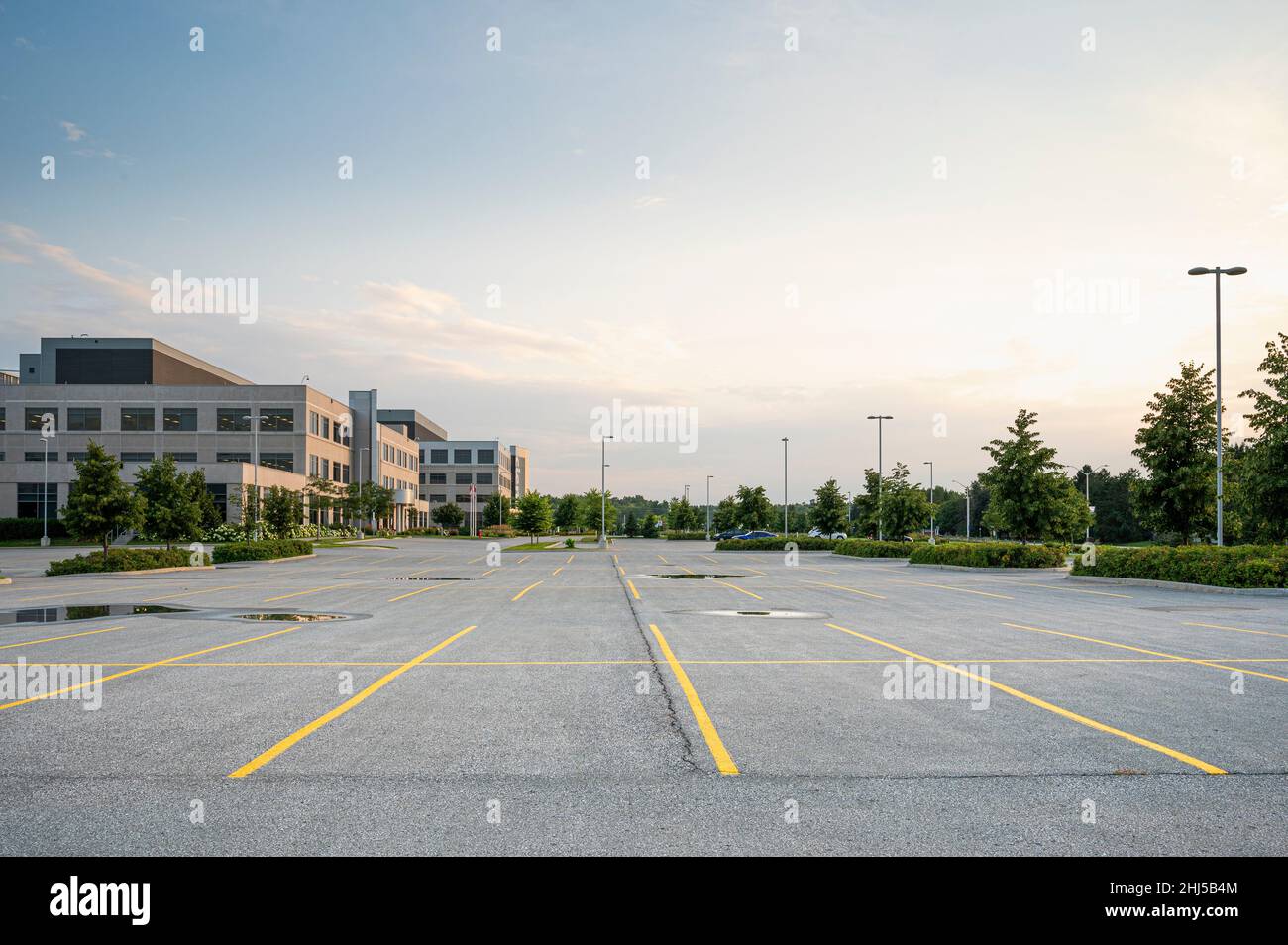 Empty parking lot next to office building. Stock Photo