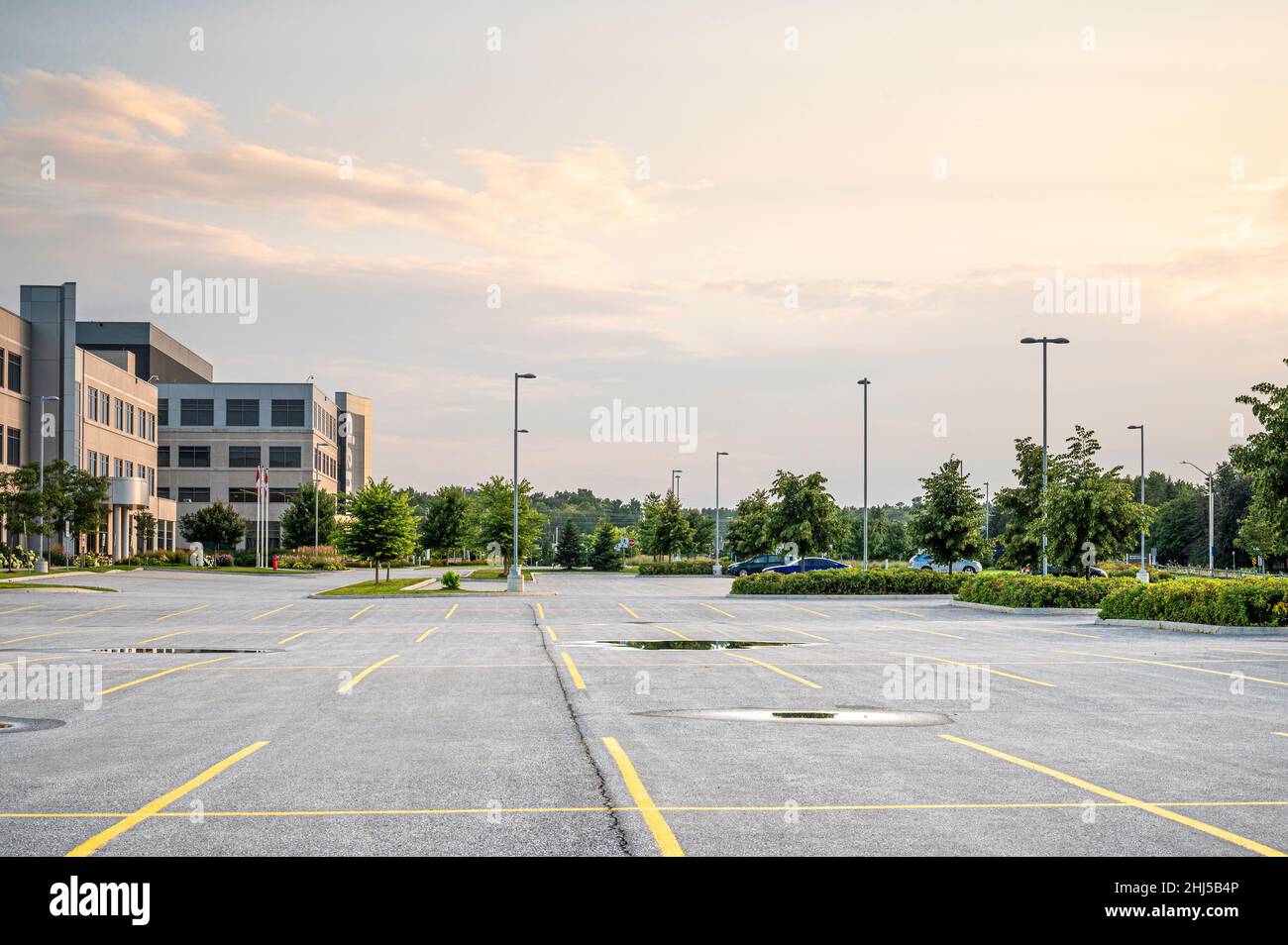 Empty parking lot next to office building. Stock Photo