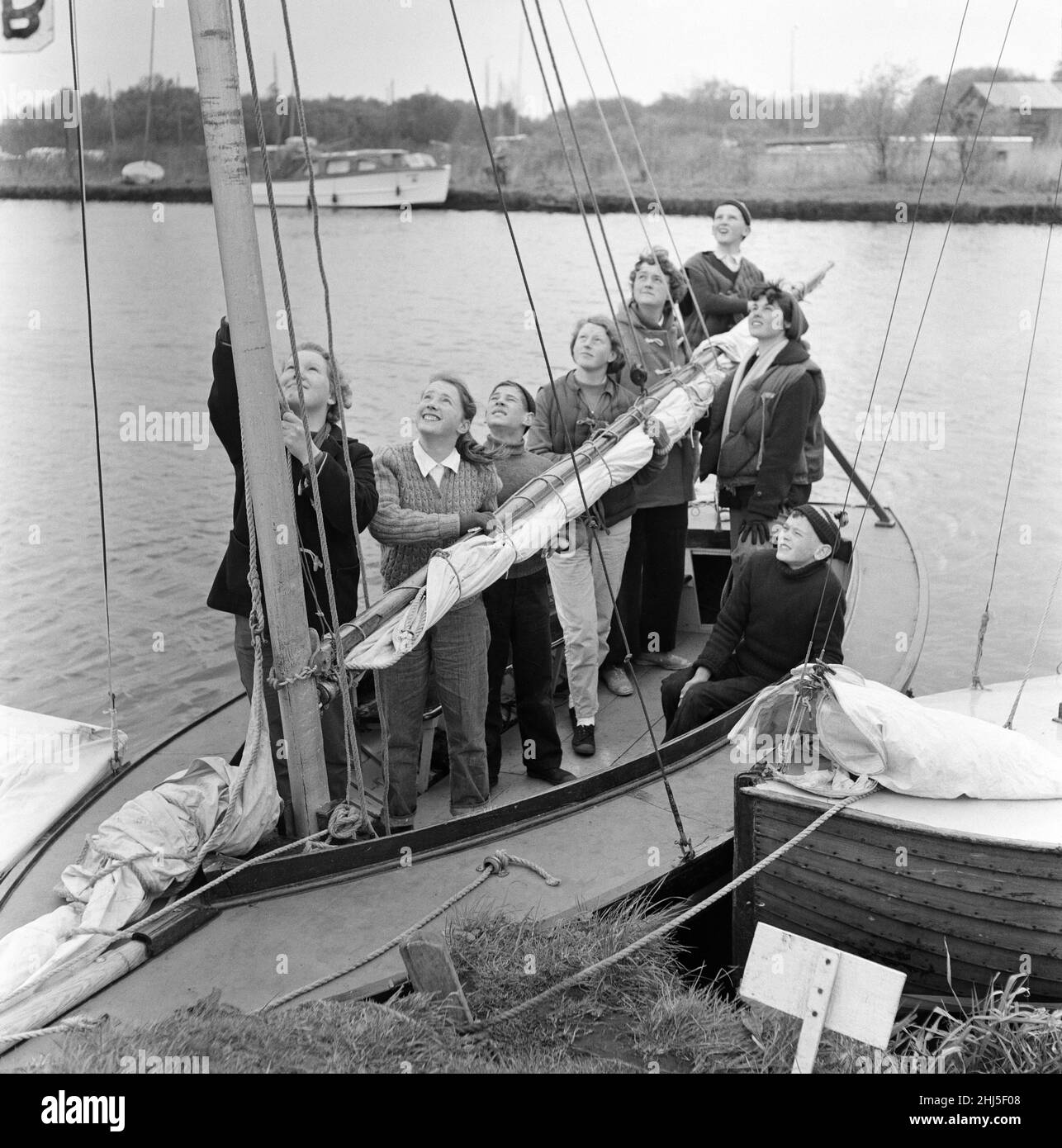 Pupils of Clarendon Secondary Modern School, South Oxhey, Watford, Hertfordshire, taking a course in yachting and seamanship on the Norfolk Broads during school holidays. The children aged from 12 upwards, spend a week under canvas and are able to spend the days receiving instructions on sailing vessels of various sizes. They are under the instruction of 28 year old Crafts master Allen Standley and 21 year old Maths and English teacher Yvonne Chapman. 28th April 1957. Stock Photo