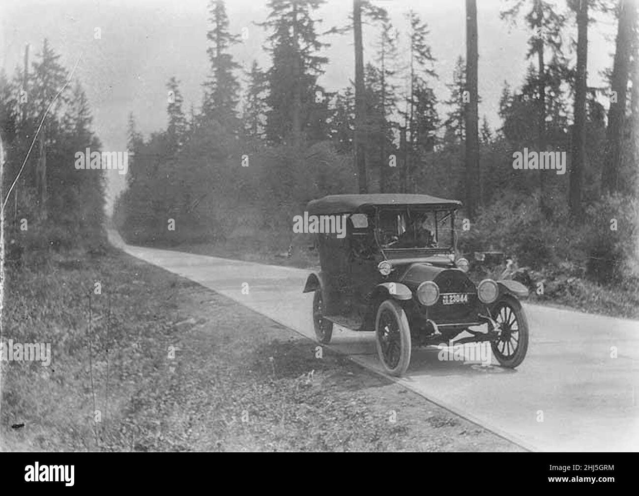 Studebaker automobile on paved road to Enumclaw, 28 miles east of Auburn, June 4, 1920 (WAITE 120). Stock Photo