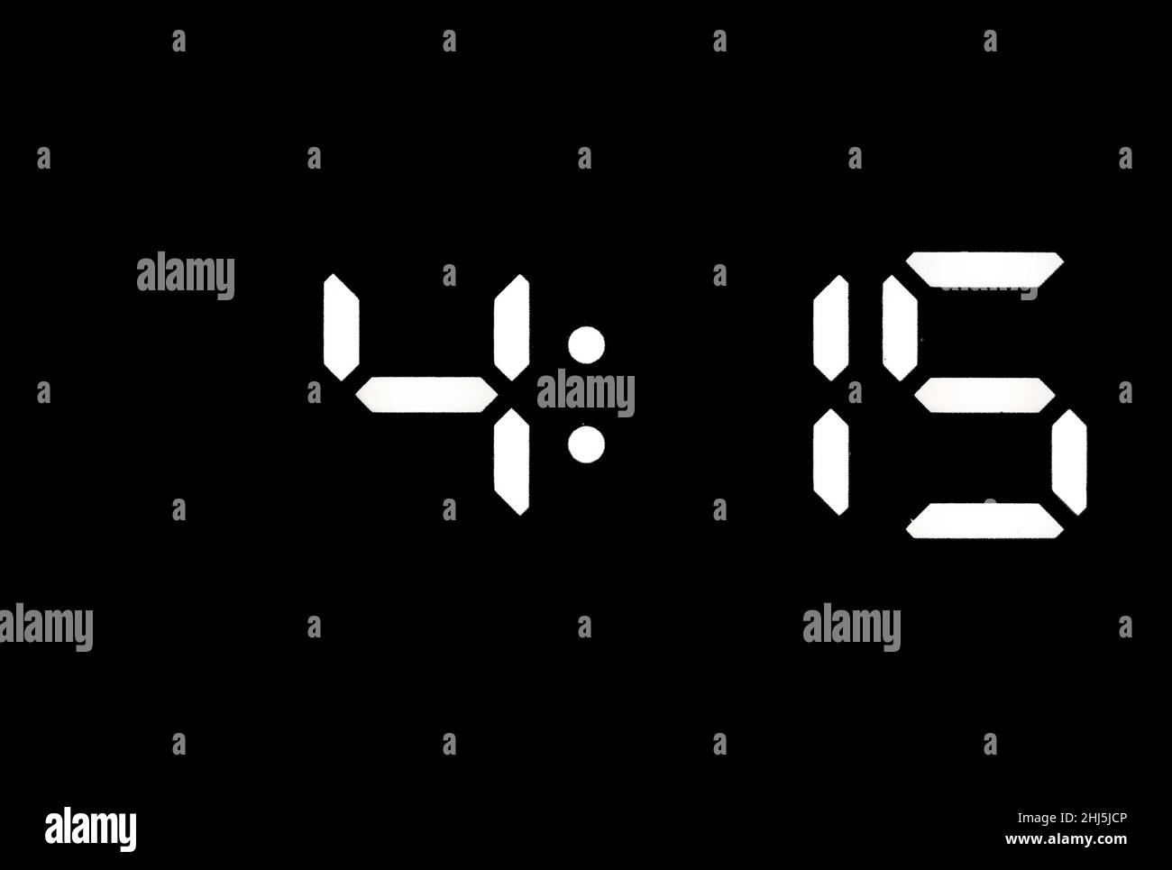 Real white led digital clock on a black background showing time 415 Stock Photo Alamy