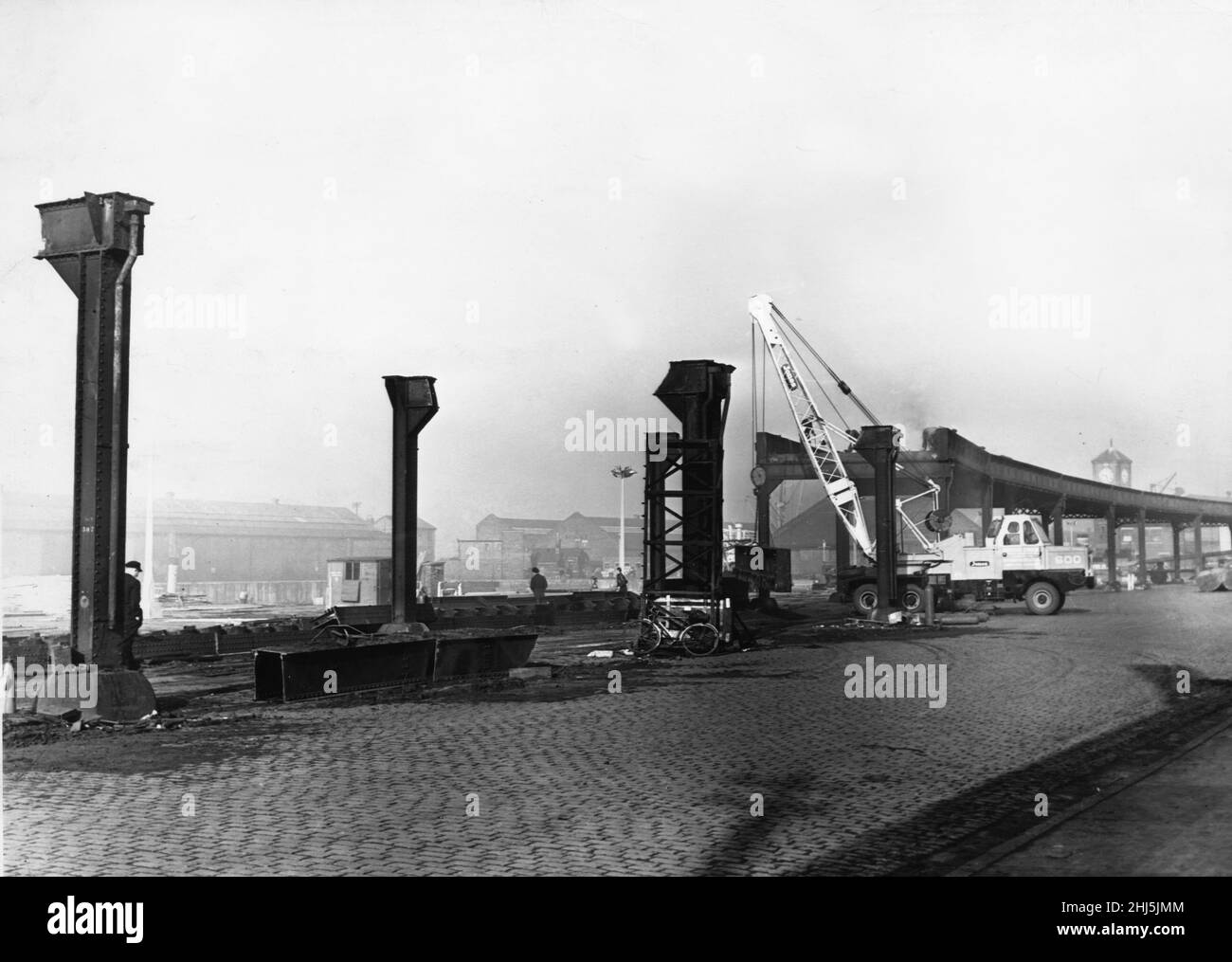 The dismantling of the Liverpool Overhead Railway. The railway stretched from as far as Dingle in the south to Seaforth & Litherland.Demolition in the North. Demolition of the structure commenced on 23 September 1957, and all 80 acres of elevated track were removed by January the following year. This picture was taken at Herculaneum Dock where 250 feet sections of the upper steel structure have been removed. Picture dated: 26th September 1957. Stock Photo