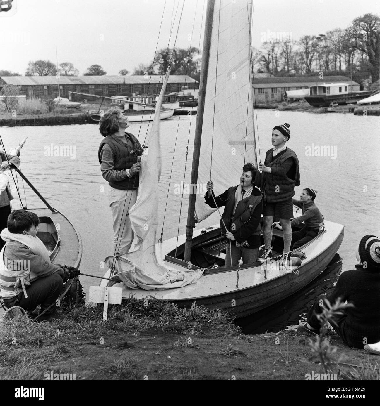 Pupils of Clarendon Secondary Modern School, South Oxhey, Watford, Hertfordshire, taking a course in yachting and seamanship on the Norfolk Broads during school holidays. The children aged from 12 upwards, spend a week under canvas and are able to spend the days receiving instructions on sailing vessels of various sizes. They are under the instruction of 28 year old Crafts master Allen Standley and 21 year old Maths and English teacher Yvonne Chapman. 28th April 1957. Stock Photo
