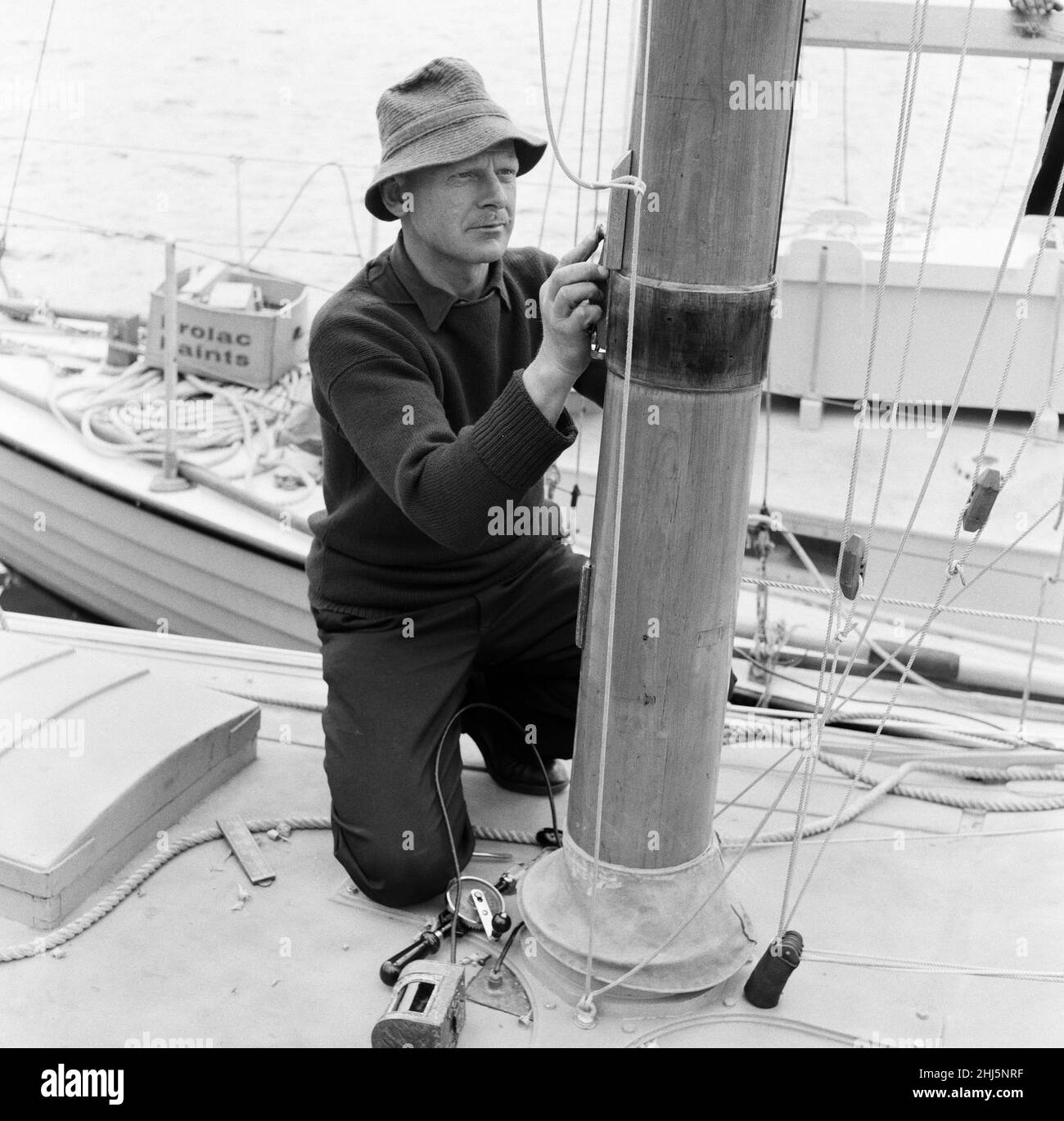 The Single-handed Trans-Atlantic Race was conceived by Herbert 'Blondie' Hasler in 1956. Pictued, Herbert George 'Blondie' Hasler, (one of the Cockelshell heroes) of yacht Jester, working on the deck. Pictured a few days ahead of the single handed trans atlantic yacht race starting from Plymouth. 9th June 1960. Stock Photo