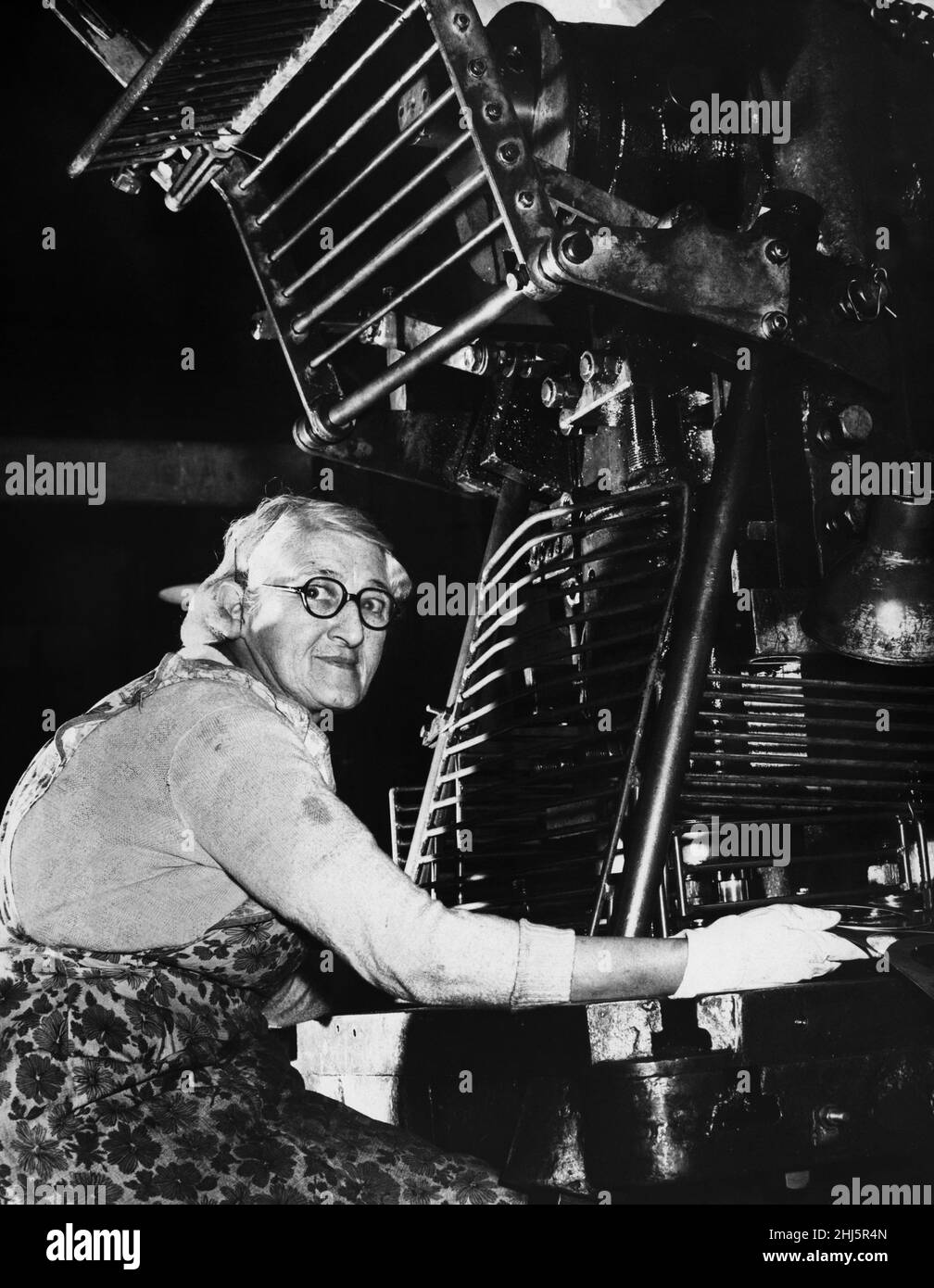 Miss Carrie Brooks at work on her Power Press.20th December 1957 Stock