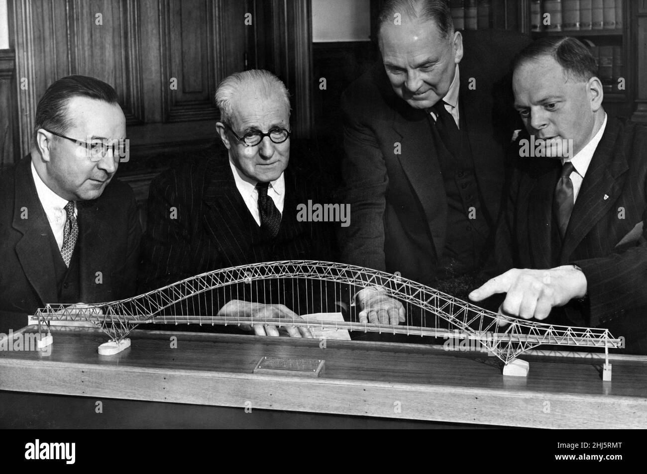 Mr M.F Howarth (Widnes Town Clerk), Alderman J.T Clayton (chairman of the the Joint Committee), Councillor D. McCulloch and Mr. Kenneth Anderson (consulting engineer) looking at a three and a half feet scale model of the new Runcorn-Widnes road bridge. 30th October 1956. Stock Photo