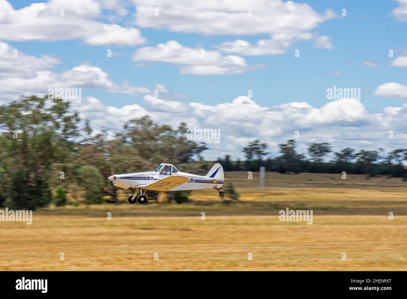 A 1967 Piper PA-25-235 Pawnee airplane just airborne towing a glider at Lake Keepit Soaring Club Gunnedah Australi. Stock Photo