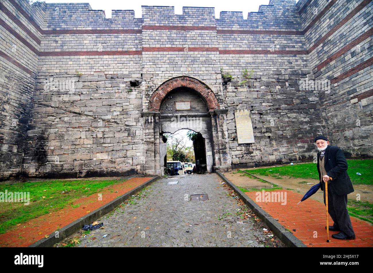 An elderly Turkish man standing by the Walls of Constantinople in Istanbul, Turkey. Stock Photo