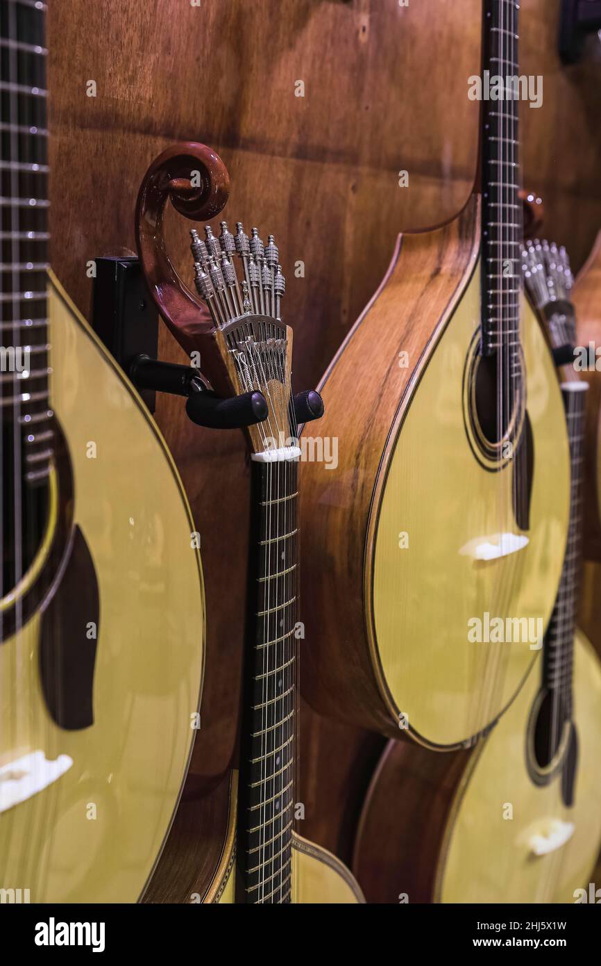 Traditional 12 string acoustic Portuguese guitar or guitarra for sale on display in a musical instrument shop in Porto, Portugal Stock Photo
