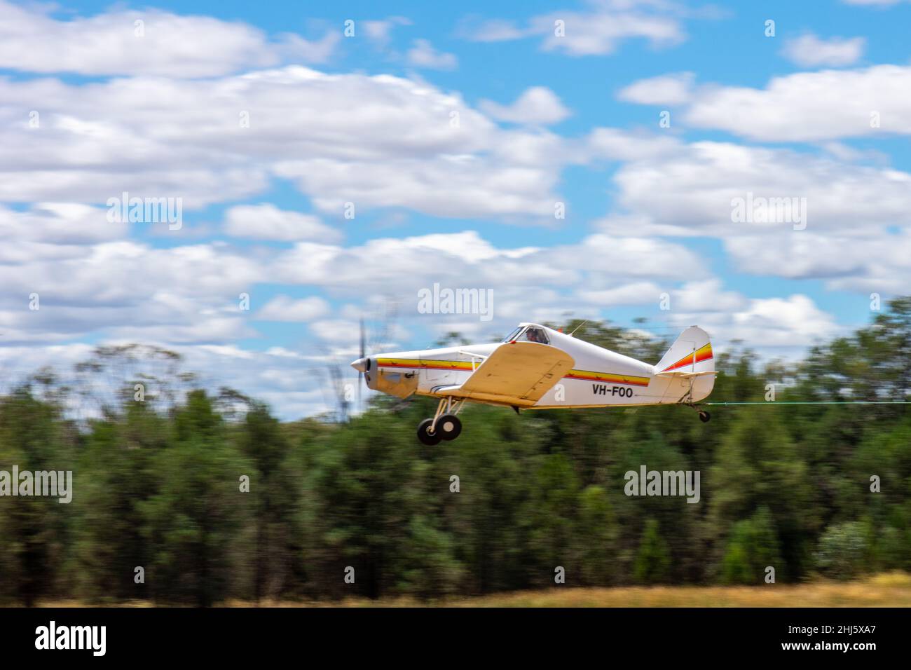 A modified Piperr Pawnee PA-25-235/A1 tug plane taking off towing a glider at Lake Keepit airfield Gunnedah Australia.  Registered FOO. Stock Photo