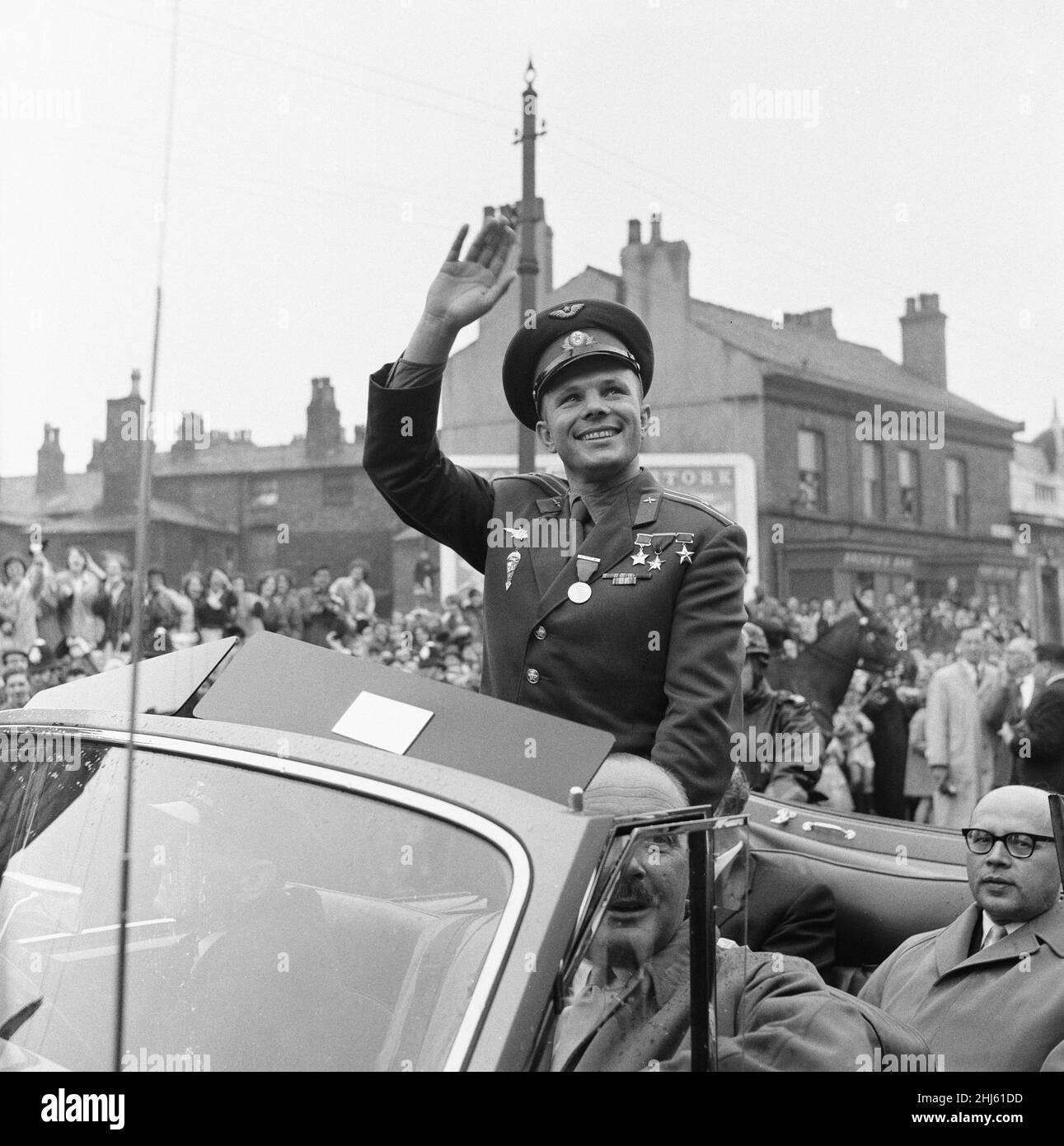 Yuri Gagarin,  Soviet Cosmonaut, the first human to journey into outer space when his Vostok spacecraft completed an orbit of the Earth (12th April 1961), visits Britain, Tuesday 11th July 1961. Our picture shows ... Yuri Gagarin is greeted by large welcoming crowds of people lining the streets of London, waving, cheering and clapping as his motorcade makes the 14 mile route to the Russian Embassy in Kensington Palace Gardens. Stock Photo