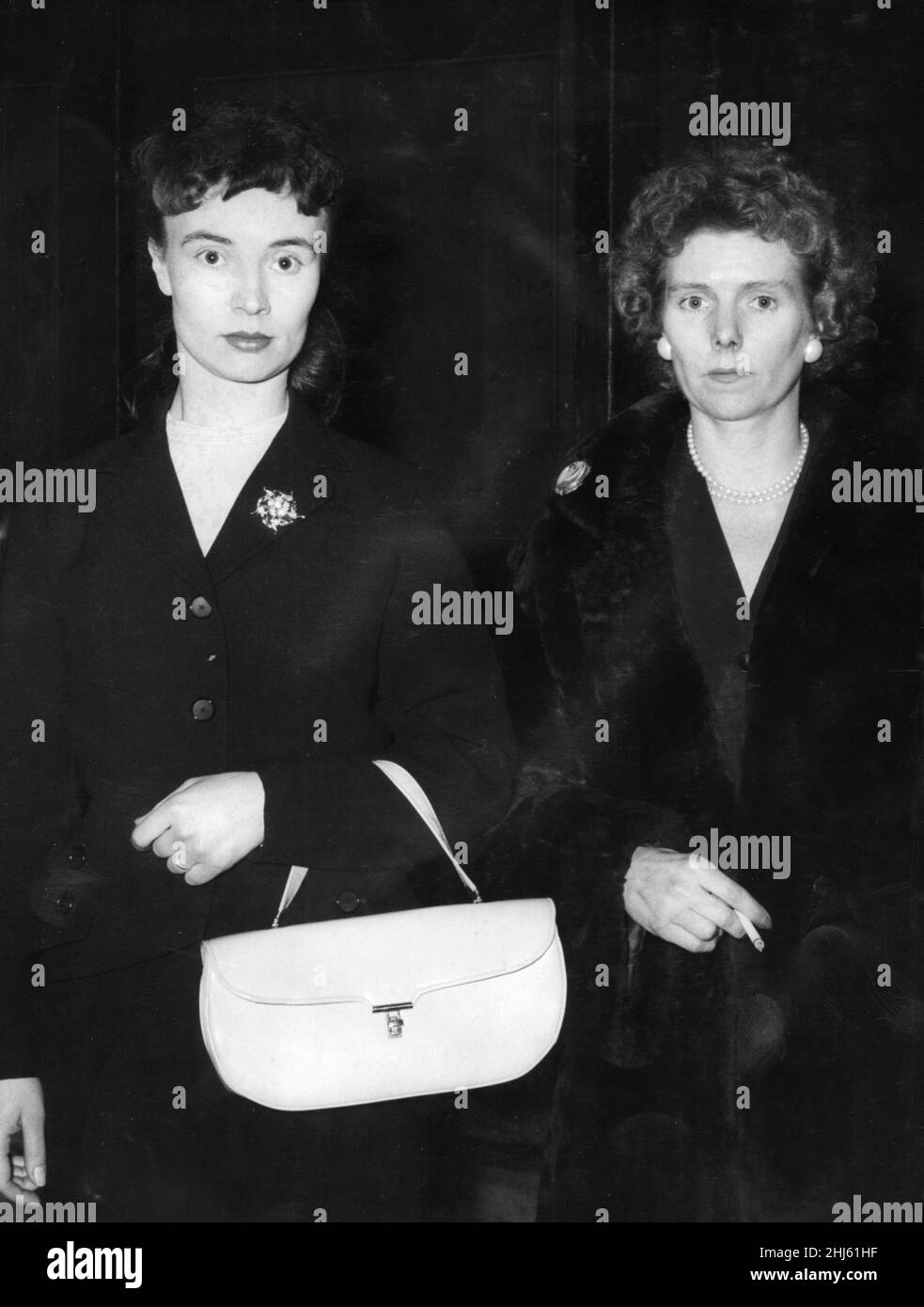 The Five Pound Note Forgery Crime of 1957. Picture shows left Mrs Elsie Ellen Small, one of the accused, and right is Mrs Frances Morgan, wife of George Morgan.  Frances was acquitted.  Mr George Morgan, 37, a car dealer of Baskerville Road, Wandsworth was found guilty of conspiracy to forge five pound notes and of possessing 540 forged notes.  He was jailed for eight years in January 1958. The first man to be tried for the crime was Albert Small who was jailed in December 1957.   A total of 5 people was tried at The Old Bailey in connection with the forging and printing of five pound notes an Stock Photo