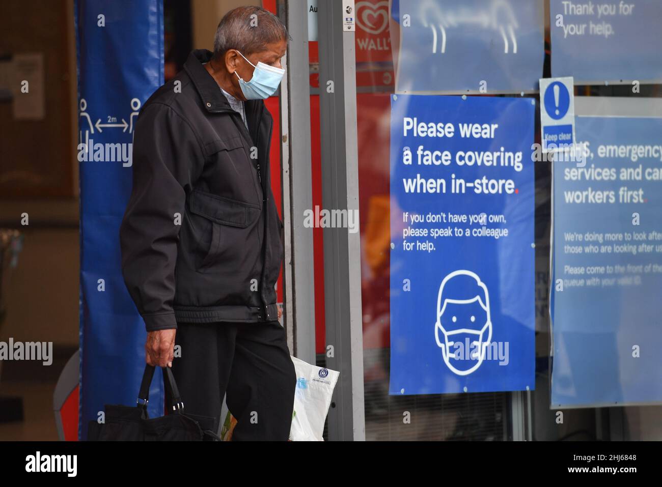 File photo dated 24/07/20 of a shopper wearing a face mask leaving Tesco in Leicester city centre, as legal measures requiring masks and Covid passes in England have been dropped, but shoppers and commuters in some settings will still be asked to wear face coverings. Stock Photo