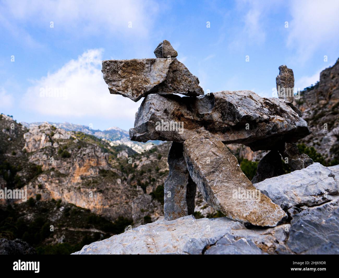 Rough rocks balancing on each other creating a dog silhouette in the ...