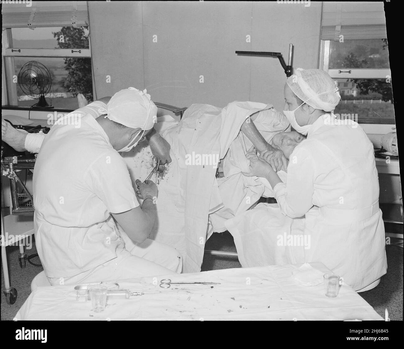 Surgeon putting pin in broken hip of an old lady. Clinch Valley Clinic