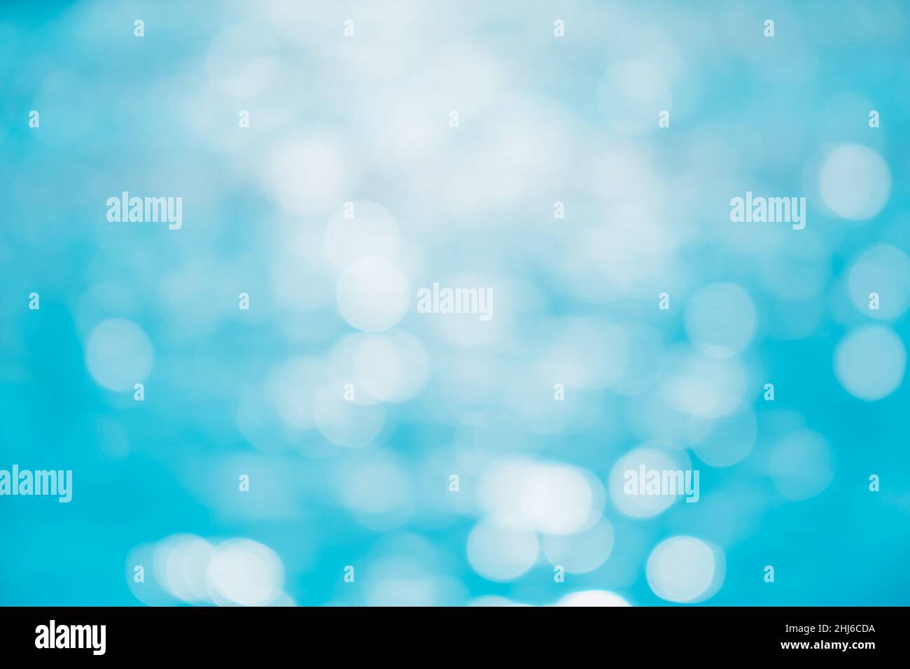Defocused blured Pure blue water in the swimming pool with light ...