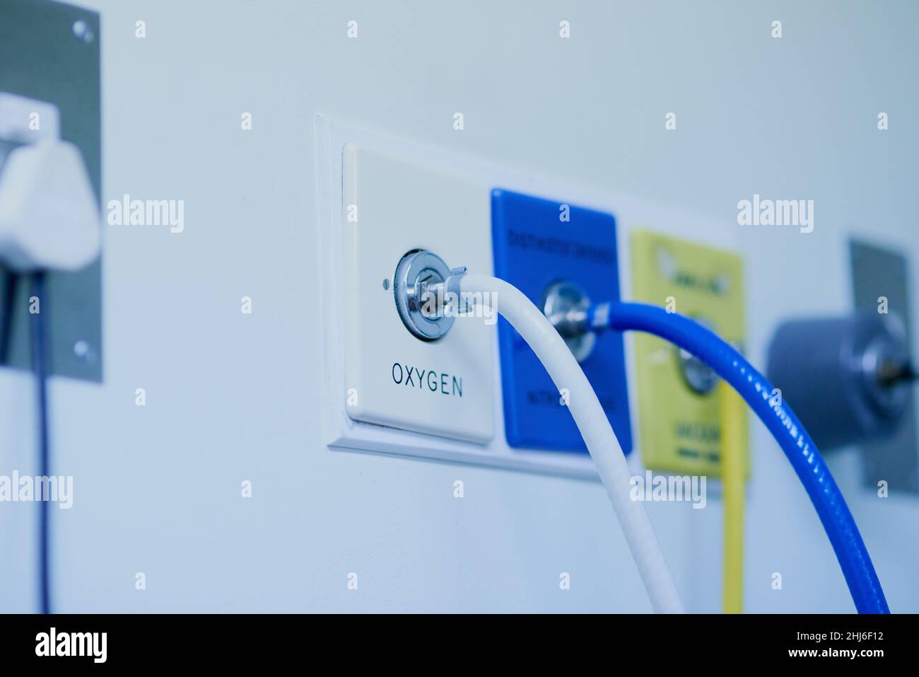 Life depends on it. Shot of tubes connected to an oxygen supply mounted against a hospital wall. Stock Photo