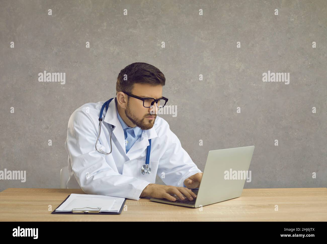 Doctor is reading the sick person. Analyzing the database in a hospital laptop Stock Photo