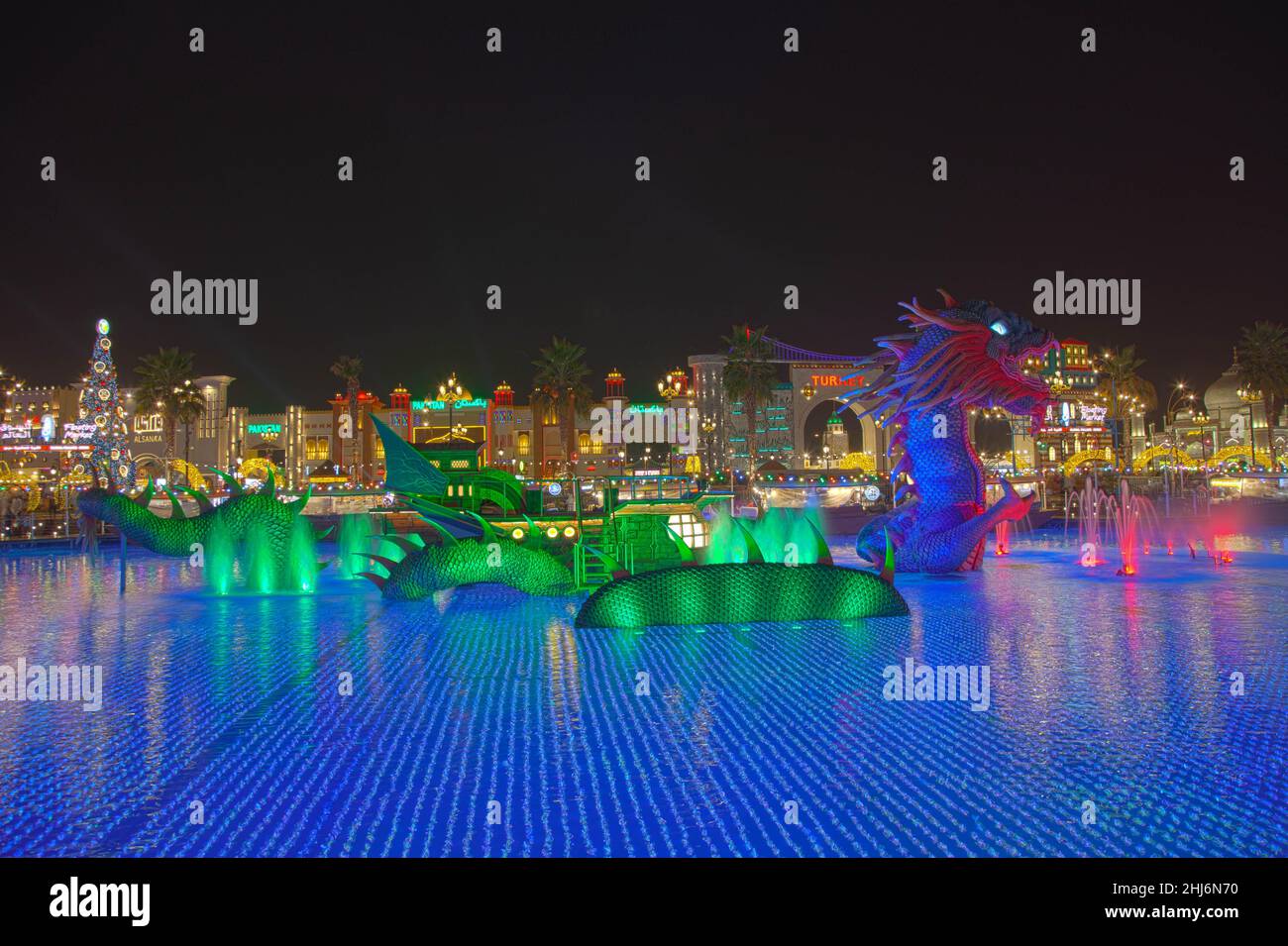 Night view of the park entertainment center with dragon at the Global Village. Stock Photo