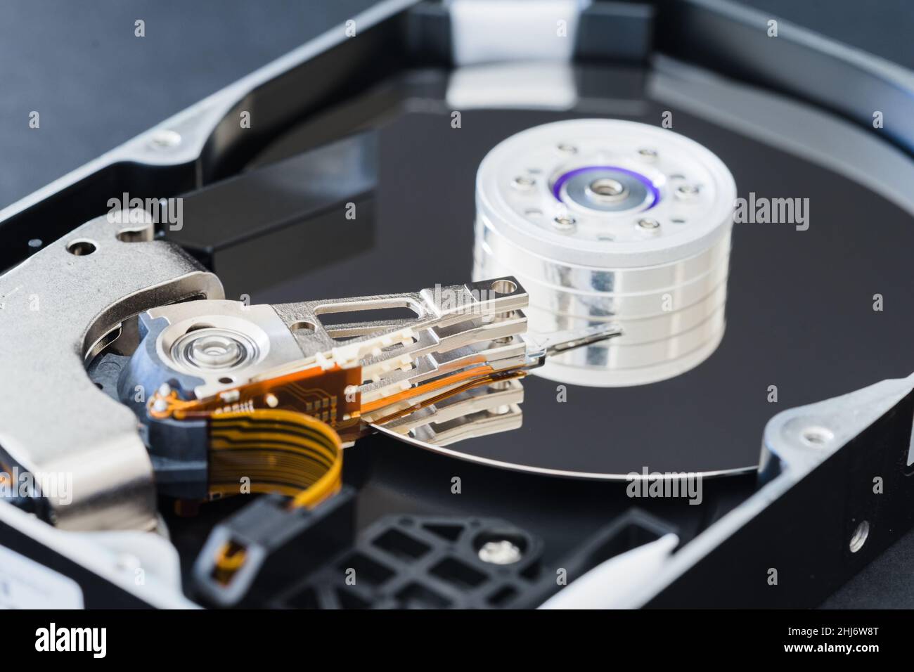 Hard disk drive inside close-up, spindle, actuator arm, read write head, platter Stock Photo