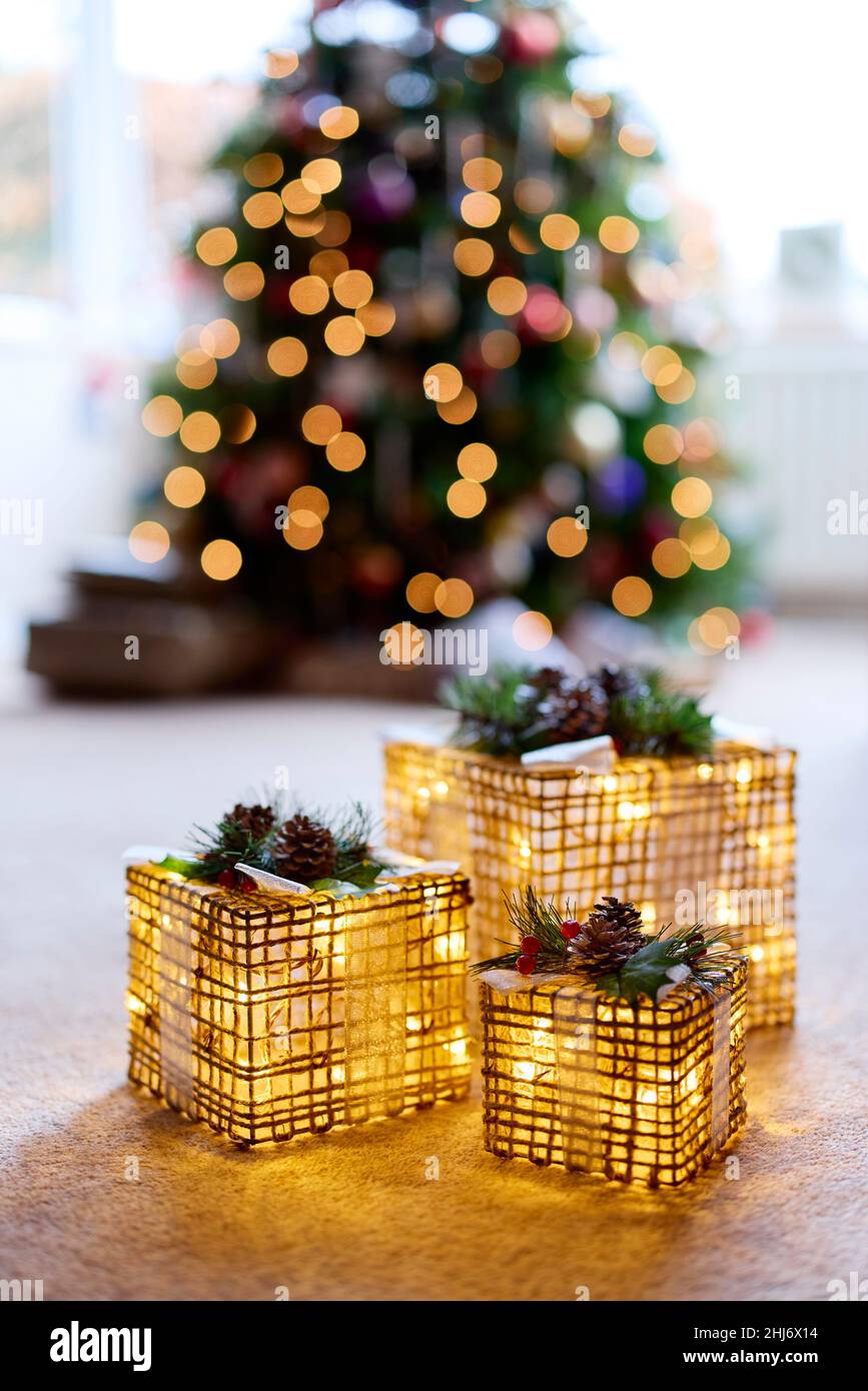 Illuminated decorations in front of Christmas Tree Stock Photo