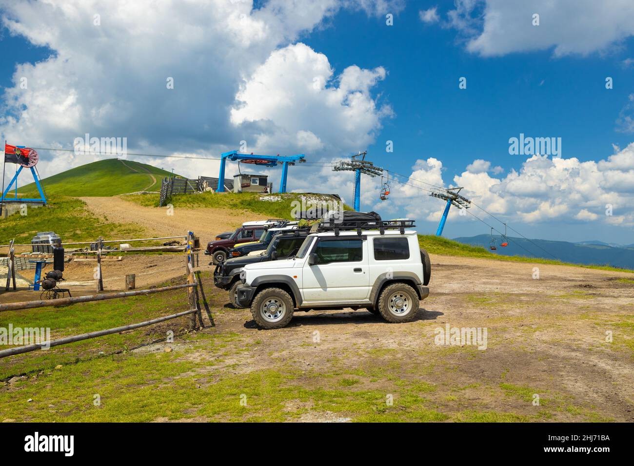 Carpathian Mountains, Ukraine - July 9, 2021: Jeep Vehicles on a Dirt Road on the top of green hills at summer time. Stock Photo