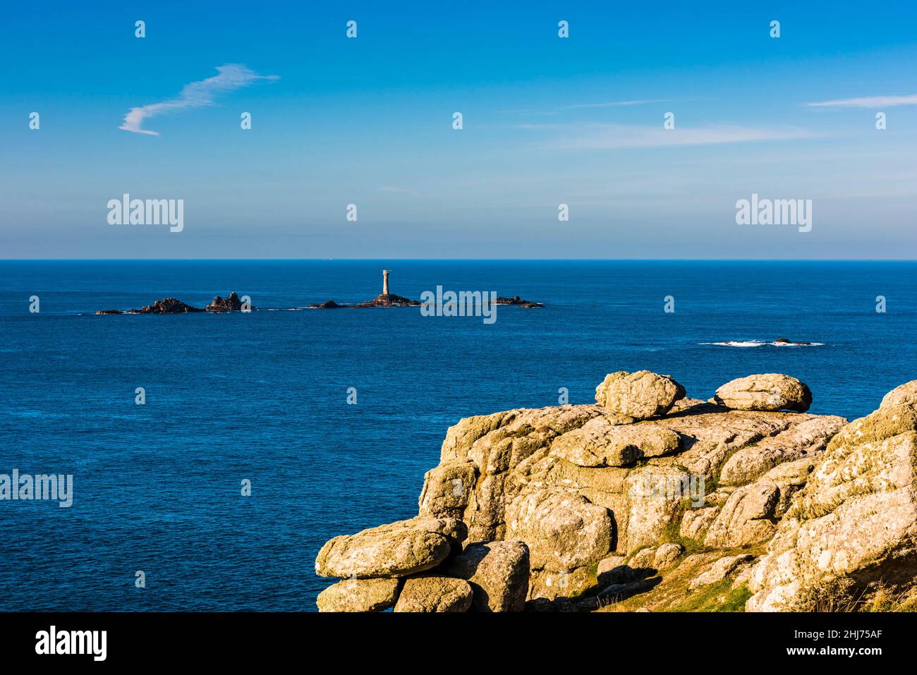 The Longships Lighthouse on Carn Bras, just off Land's End, Cornwall, UK Stock Photo